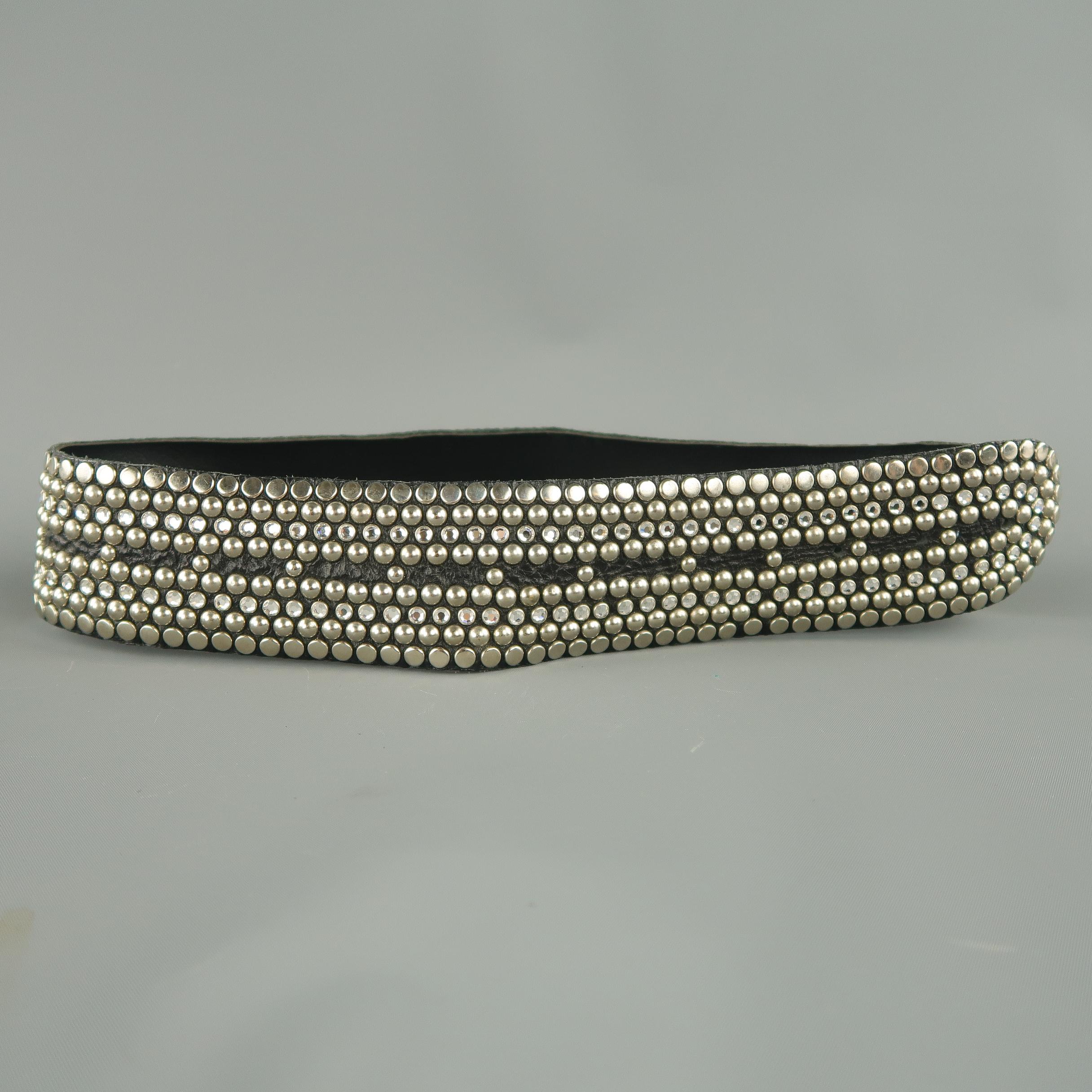 Vintage KIPPY'S belt strap comes in black leather with all over flat, dome, and rhinestone stud embellishments and metal logo. Punched holes to attach a double button stud buckle.
 
Excellent Pre-Owned Condition.
 
Measurements:
 
Length: 29
