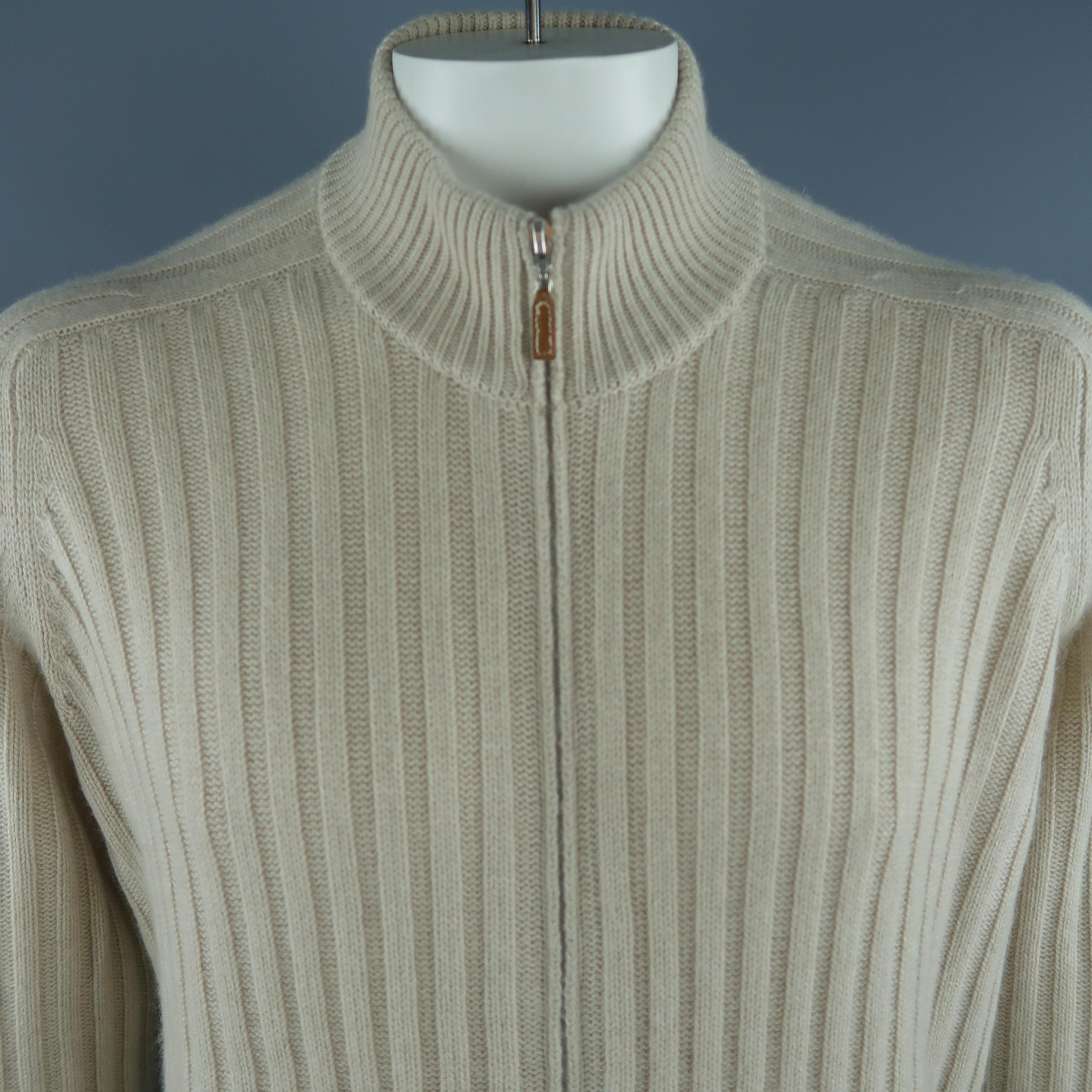 BRUNELLO CUCINELLI  cardigan come in beige tone in knitted cashmere material, with zip up front, front zip pockets, ribbed cuffs and waistband. Made in Italy.
 
New with Tags. One Pocket missing zipper pull.
Marked: 54 IT
 
Measurements:
 
Shoulder:
