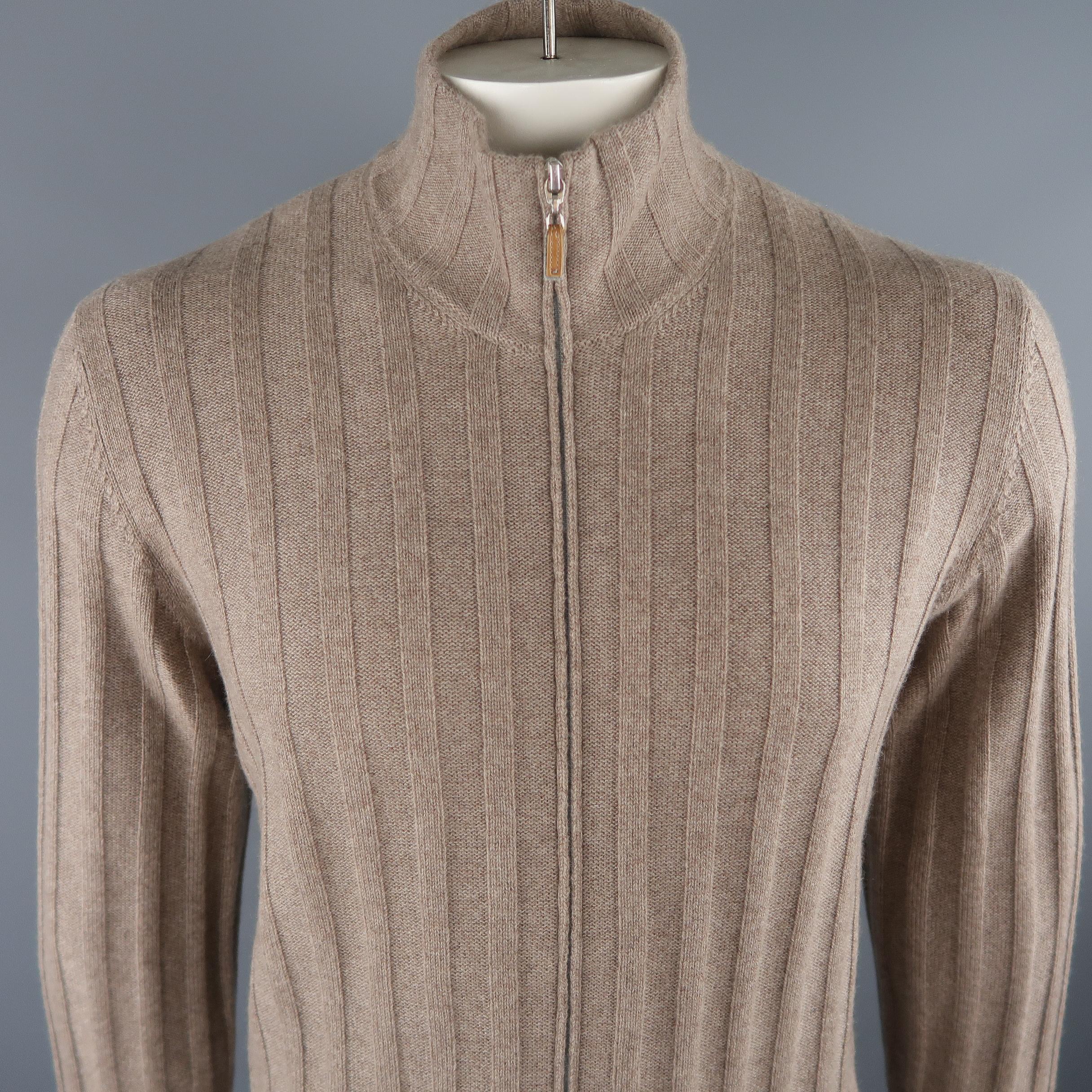 BRUNELLO CUCINELLI cardigan comes in oatmeal tone, knitted 100% cashmere material, with zip up front, ribbed cuffs and waistband. Made in Italy.
 
New with Tags.
Marked: 52 IT
 
Measurements:
 
Shoulder: 18.5 in.
Chest: 46 in.
Sleeve: 27.5 