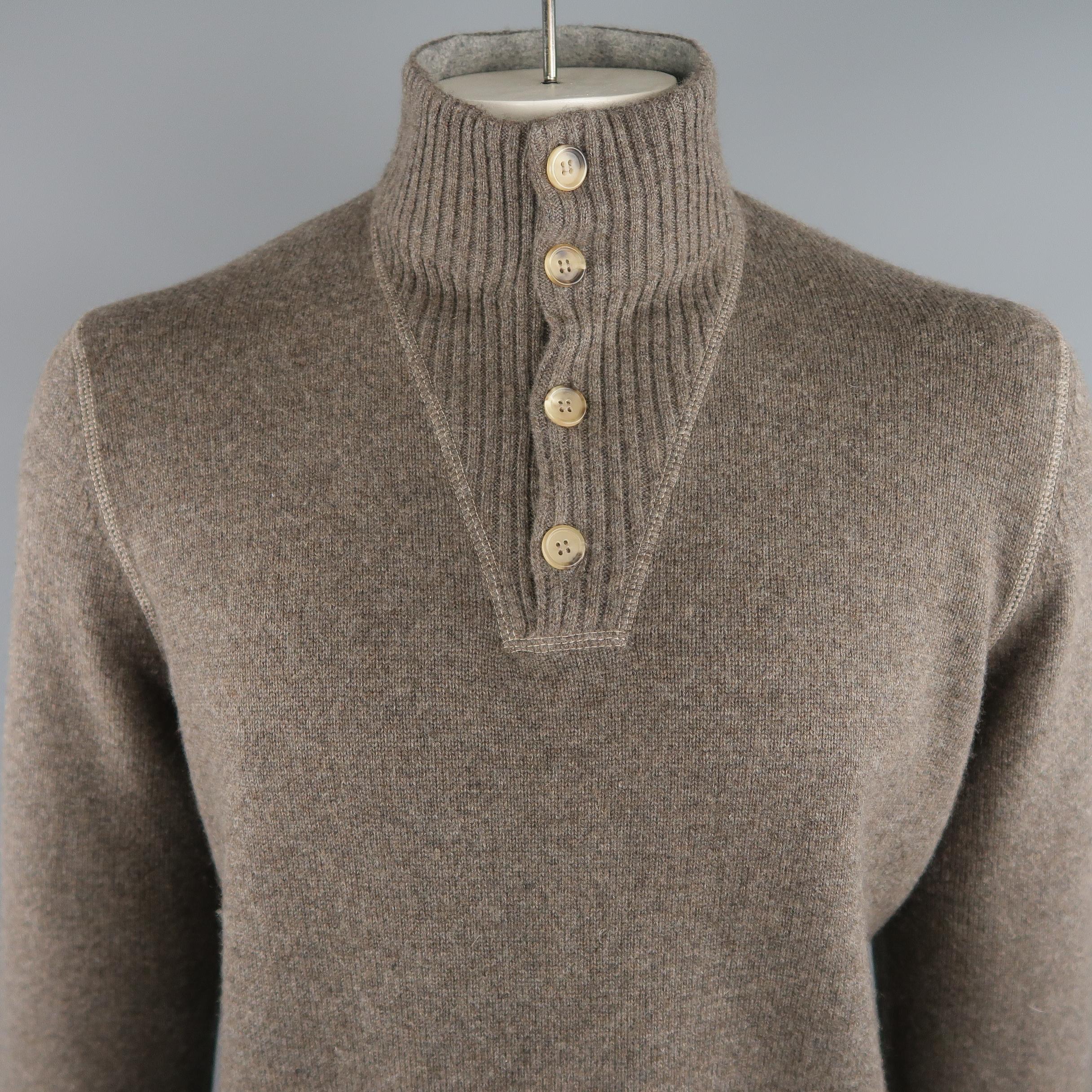 BRUNELLO CUCINELLI sweater come in taupe tone in knitted cashmere, buttoned high collar, ribbed cuffs and waistband. Made in Italy.
 
Excellent Pre-Owned Condition.
Marked: 54 IT
 
Measurements:
 
Shoulder: 18 in.
Chest: 49 in.
Sleeve: 26.5 