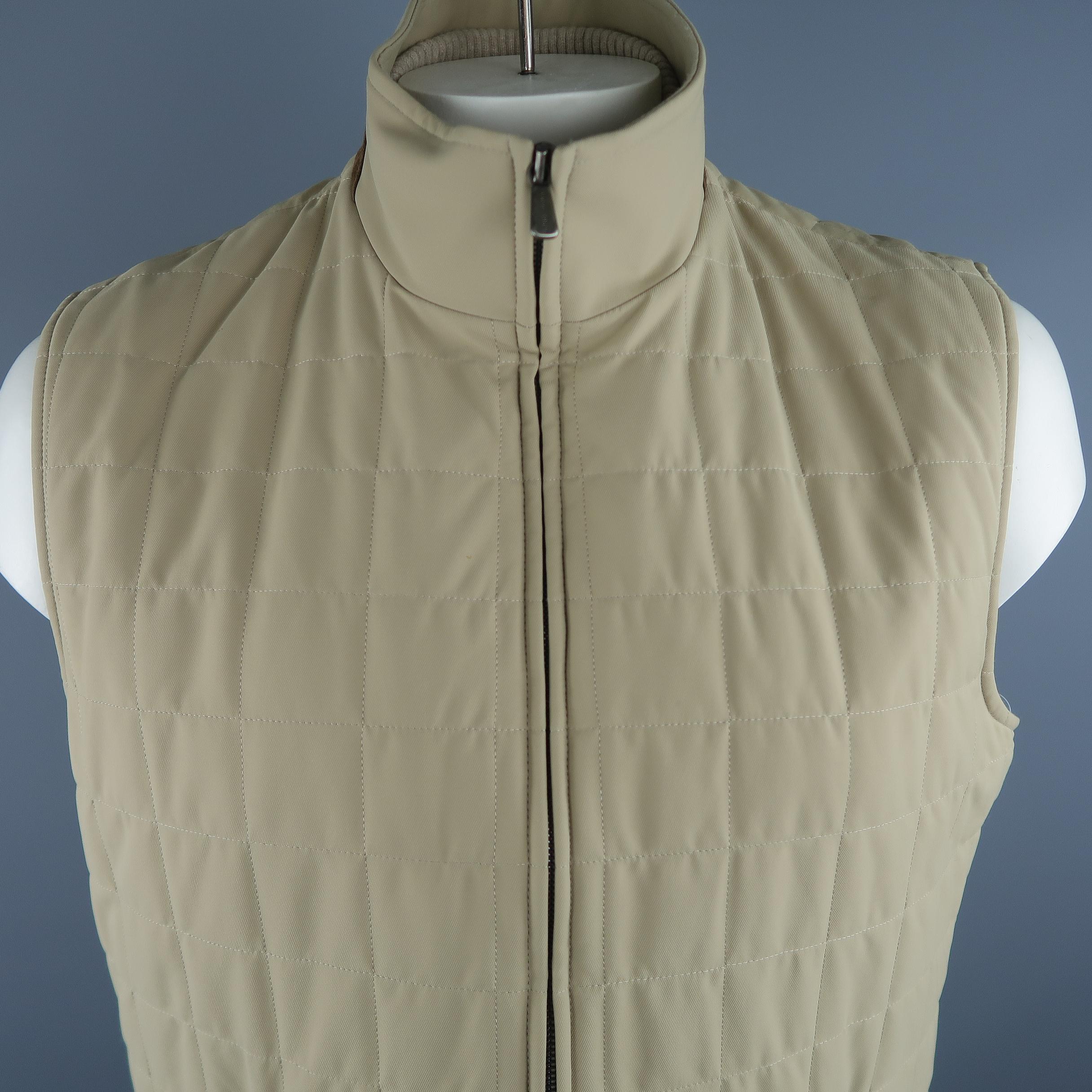 LORO PIANA vest comes in khaki quilted nylon material, suede trim on the collar, zip up and zip pockets. Made in Italy.
 
Excellent  Pre-Owned Condition.
Marked: XL IT
 
Measurements:
 
Shoulder: 18 in.
Chest: 48 in.
Length: 27.5 in.