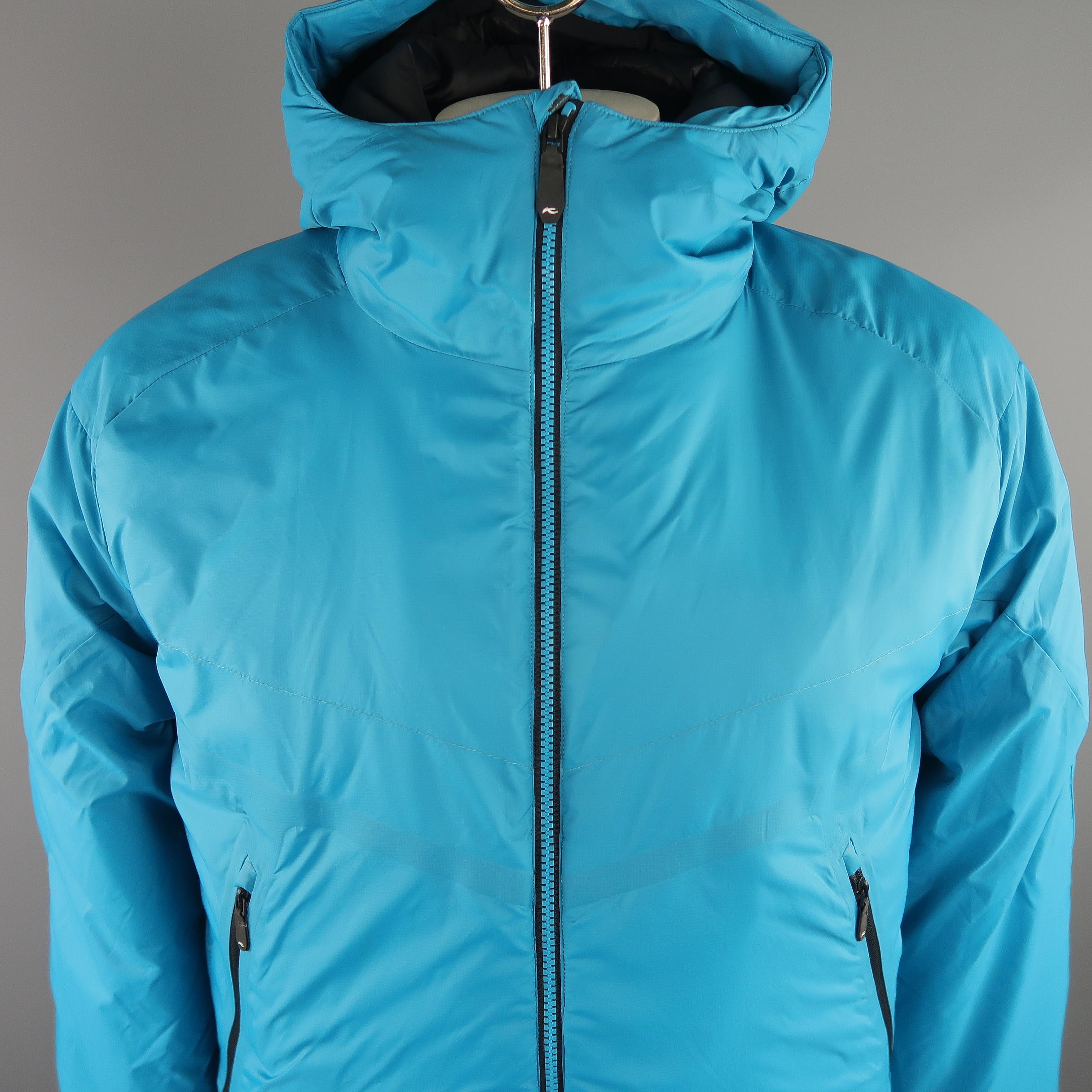 KJUS  filled hooded  jacket comes in a light weight aqua tone in polyamide solid material, zip up, slit pockets. Made in Italy.
 
New without Tags.
Marked: 52 / L  
 
Measurements:
 
Shoulder: 20 in.
Chest: 46 in.
Sleeve: 27 in.
Length: 30 in.