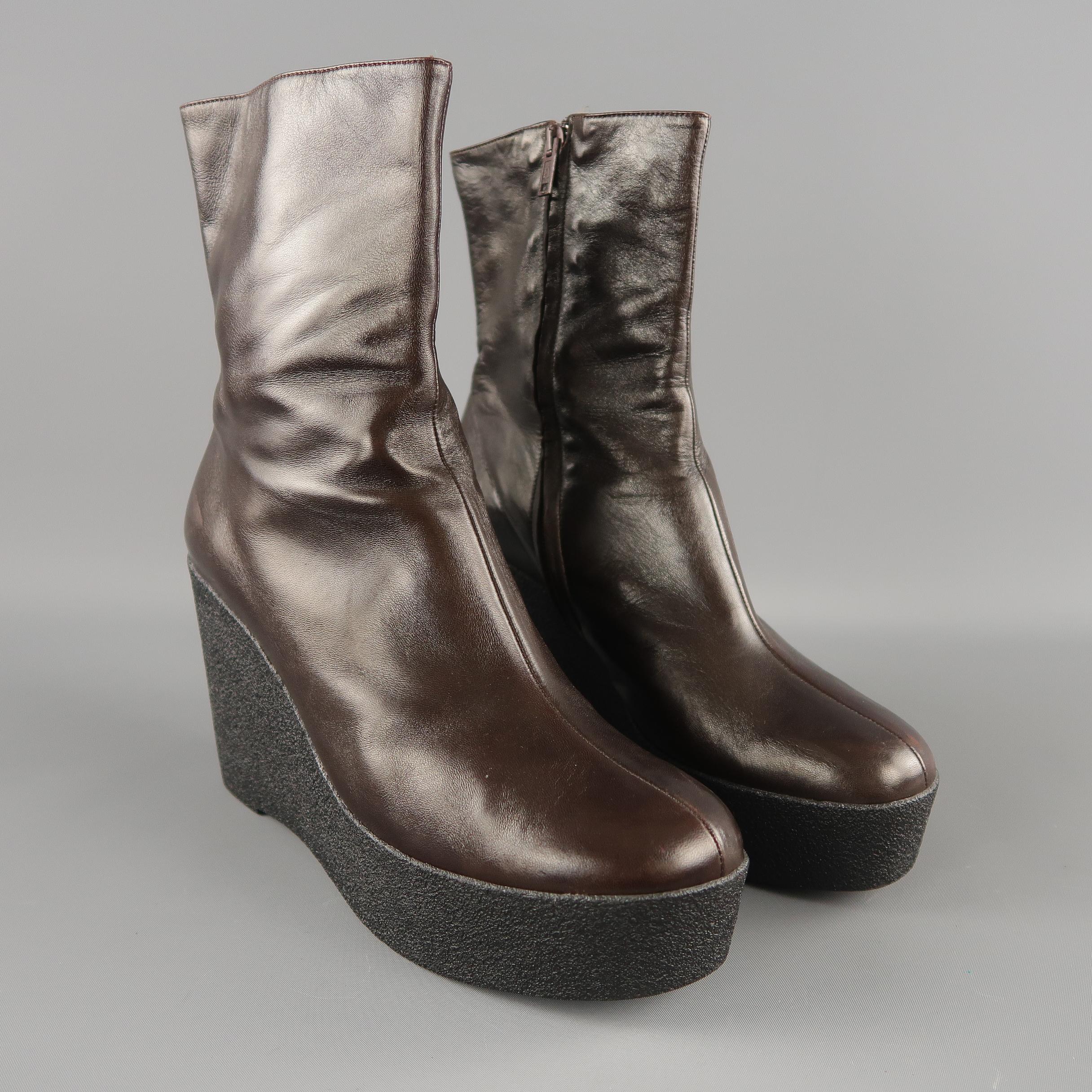 ROBERT CLERGERIE ankle boots come in chocolate brown smooth leather with a round toe, inner zip, and black crepe platform wedge. Like new. Made in France.
 
Excellent Pre-Owned Condition. Retails: $575.00.
Marked: 10
 
Measurements:
 
Heel: 4