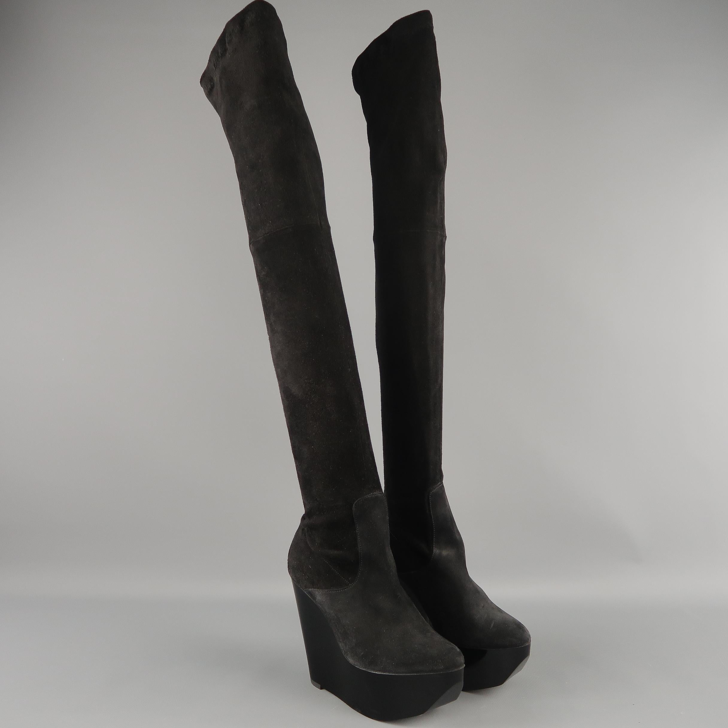 These fabulous ROBERT CLERGERIE thigh high boots come in black stretch bonded suede with a rounded point toe and angular lacquered platform wedge. Made in France.
 
Good Pre-Owned Condition. Retails: $795.00.
Marked: 5
 
Measurements:
 
Heel: 4.5