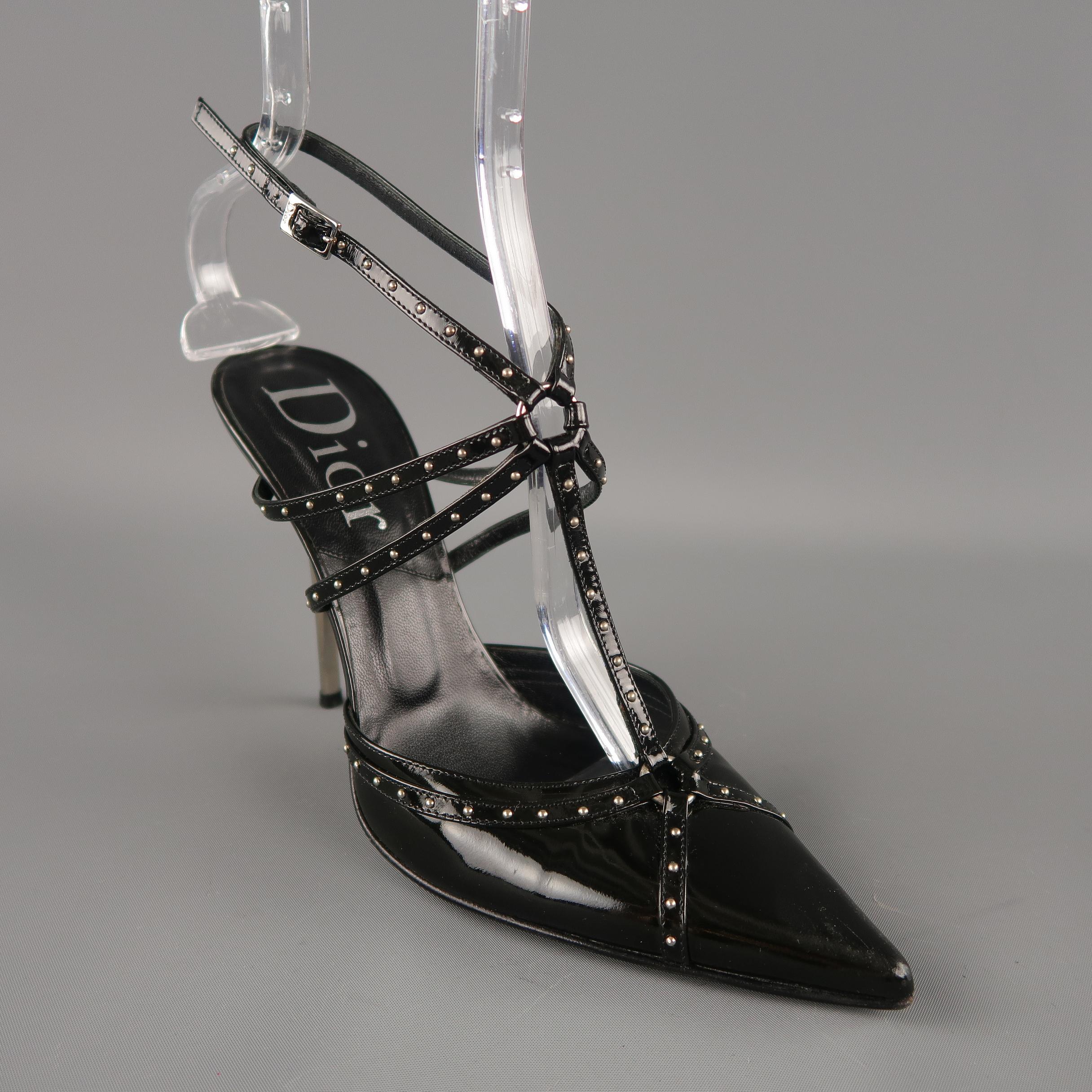Archive CHRISTIAN DIOR by JOHN GALLIANO pumps come in black patent leather with a pointed toe, silver tone metal stiletto heel, and studded bondage harness with slingback ankle strap. Made in Italy.
 
Excellent Pre-Owned Condition.
Marked: IT 38.5
