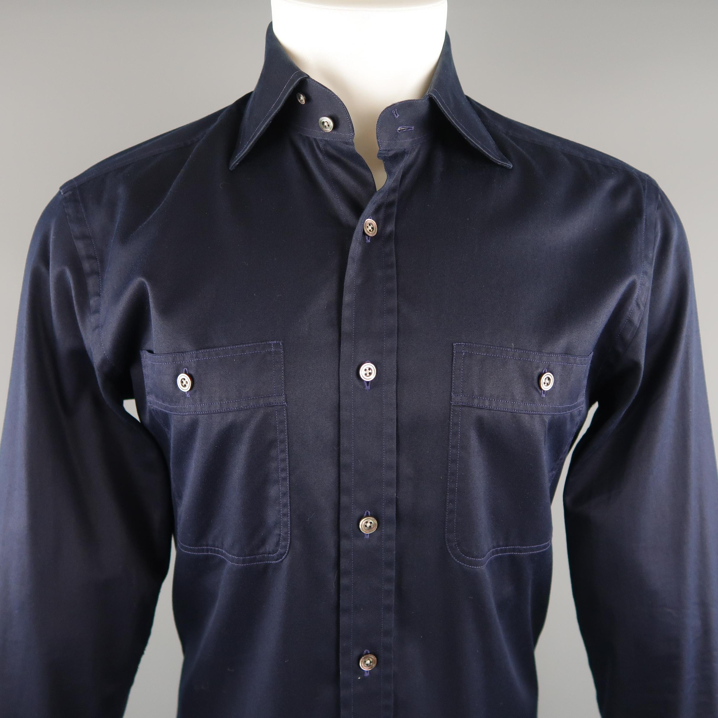 TOM FORD shirt come in a navy tone in a solid cotton, button up, patch pockets and long sleeves. Light marks of wear inside the collar. Made in Switzerland.
 
Excellent Pre-Owned Condition.
Marked: 41 IT
 
Measurements:
 
Shoulder: 17.5  in.
Chest: