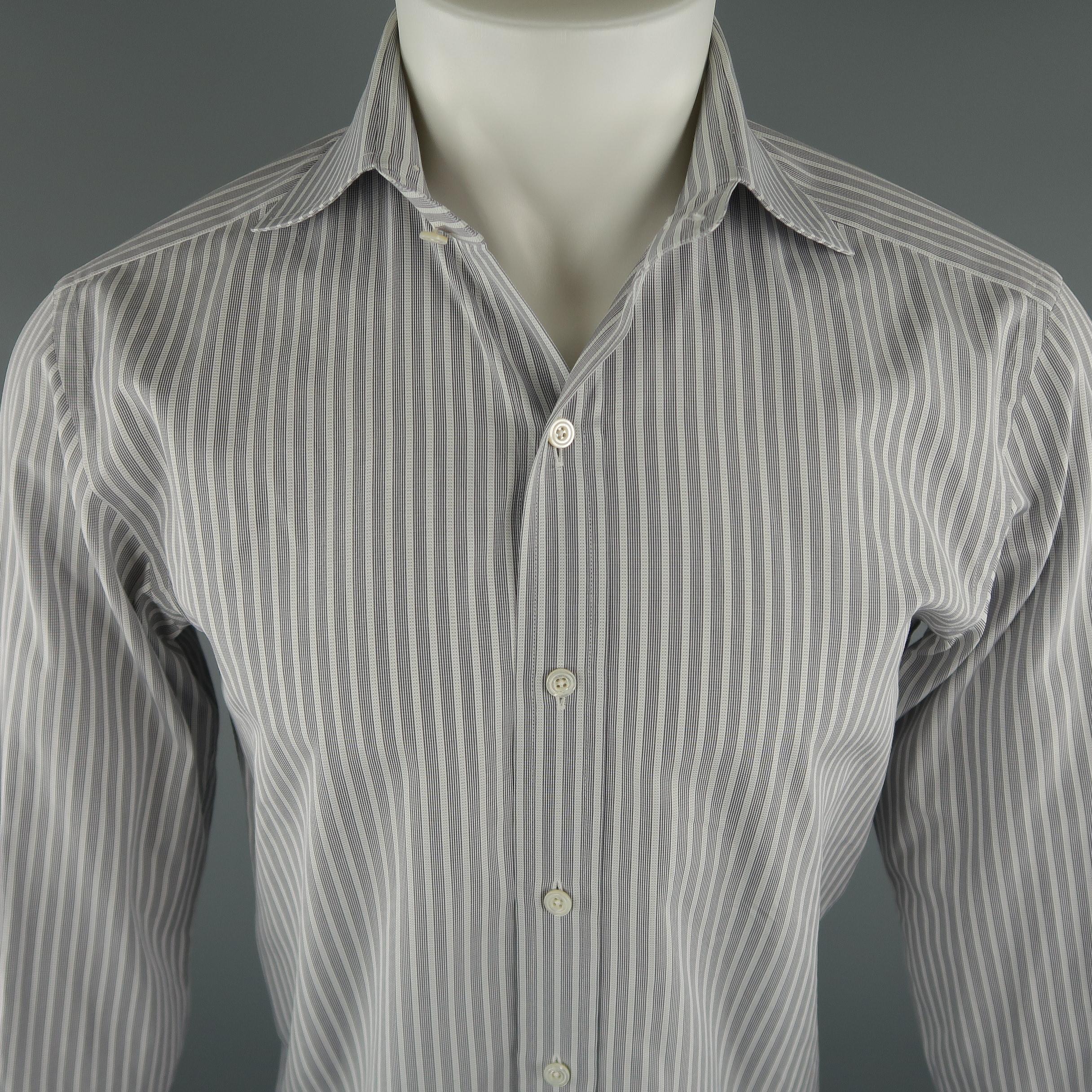 TOM FORD shirt come in grey tones, in a striped cotton material, button up, spread collar and long sleeves. Made in Switzerland.
 
Excellent Pre-Owned Condition.
Marked: 40 IT
 
Measurements:
 
Shoulder: 17 in.
Chest: 42 in.
Sleeve: 24.5 in.
Length: