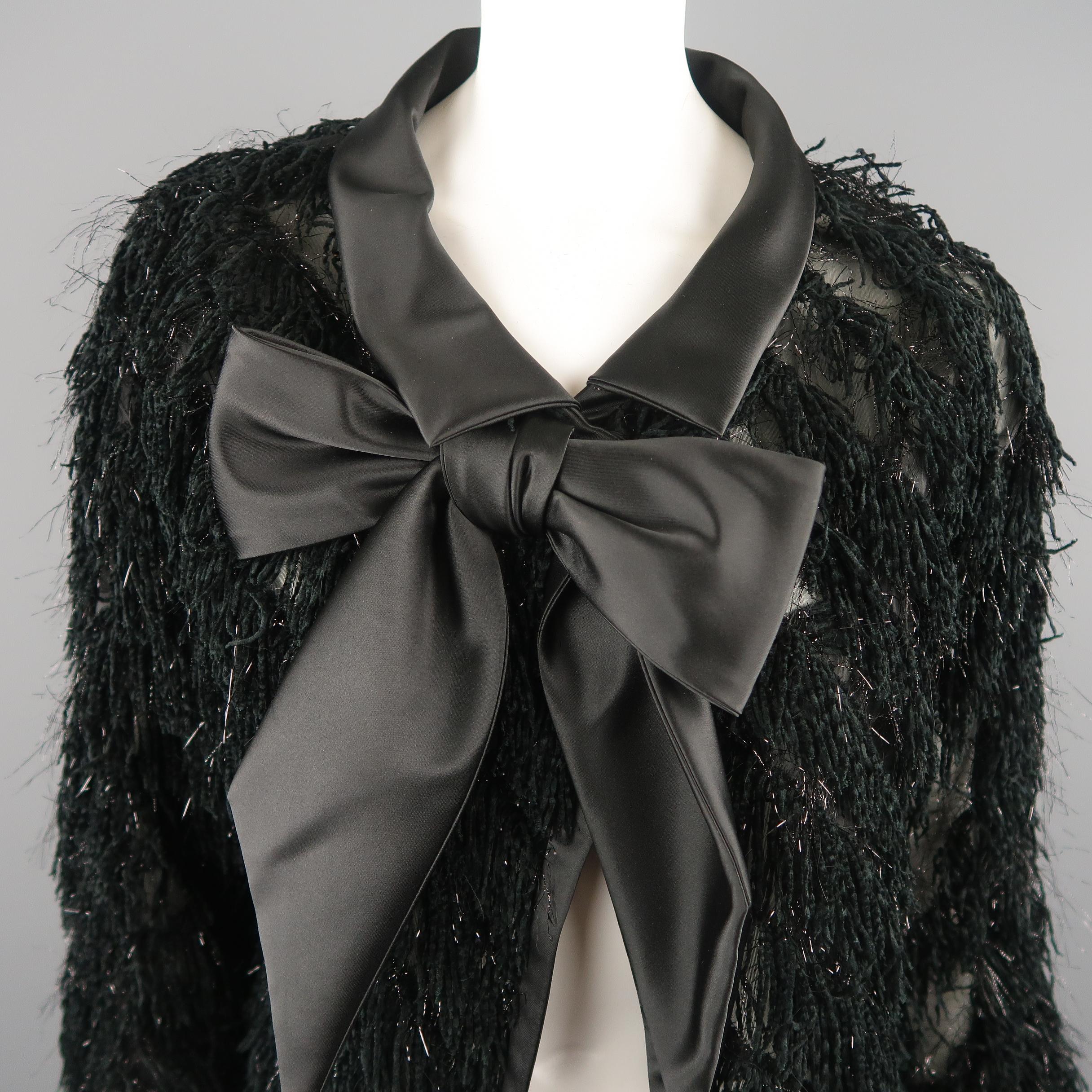 GIORGIO ARMANI evening jacket comes in a sheer material with all over diagonal fringe with a sing snap closure, pointed satin collar with bow, cropped sleeves. Made in Italy.
 
Excellent Pre-Owned Condition.
Marked: (no size)
 
Measurements:
