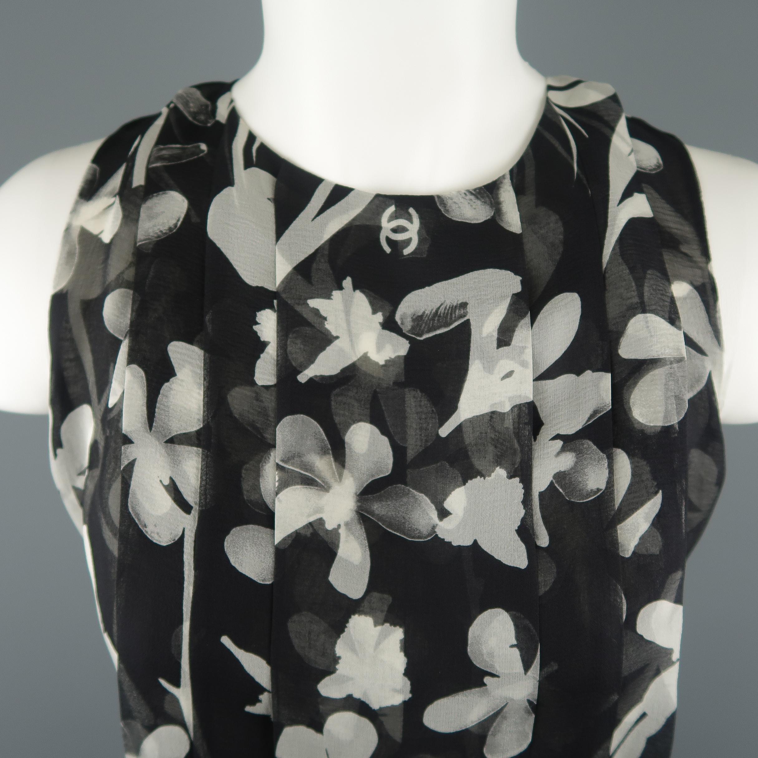 CHANEL sleeveless blouse comes in black and cream floral CC print silk chiffon with a pleated front, round neckline, and button up back. Label cut out. As-is. Made in France.
 
Good Pre-Owned Condition.
Marked: (no size)
 
Measurements:
 
Shoulder: