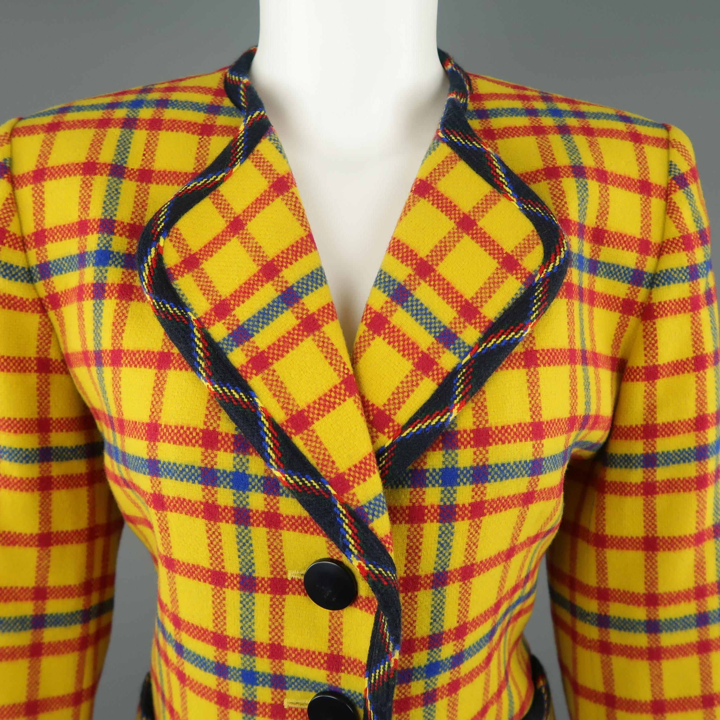 Vintage YVES SAINT LAURENT - ENCORE jacket comes in bold yellow, red, and blue plaid wool with a collarless, pointed lapel, four button front, and deep navy print piping. Minor imperfections on buttons. Made in France. .
 
Excellent Pre-Owned