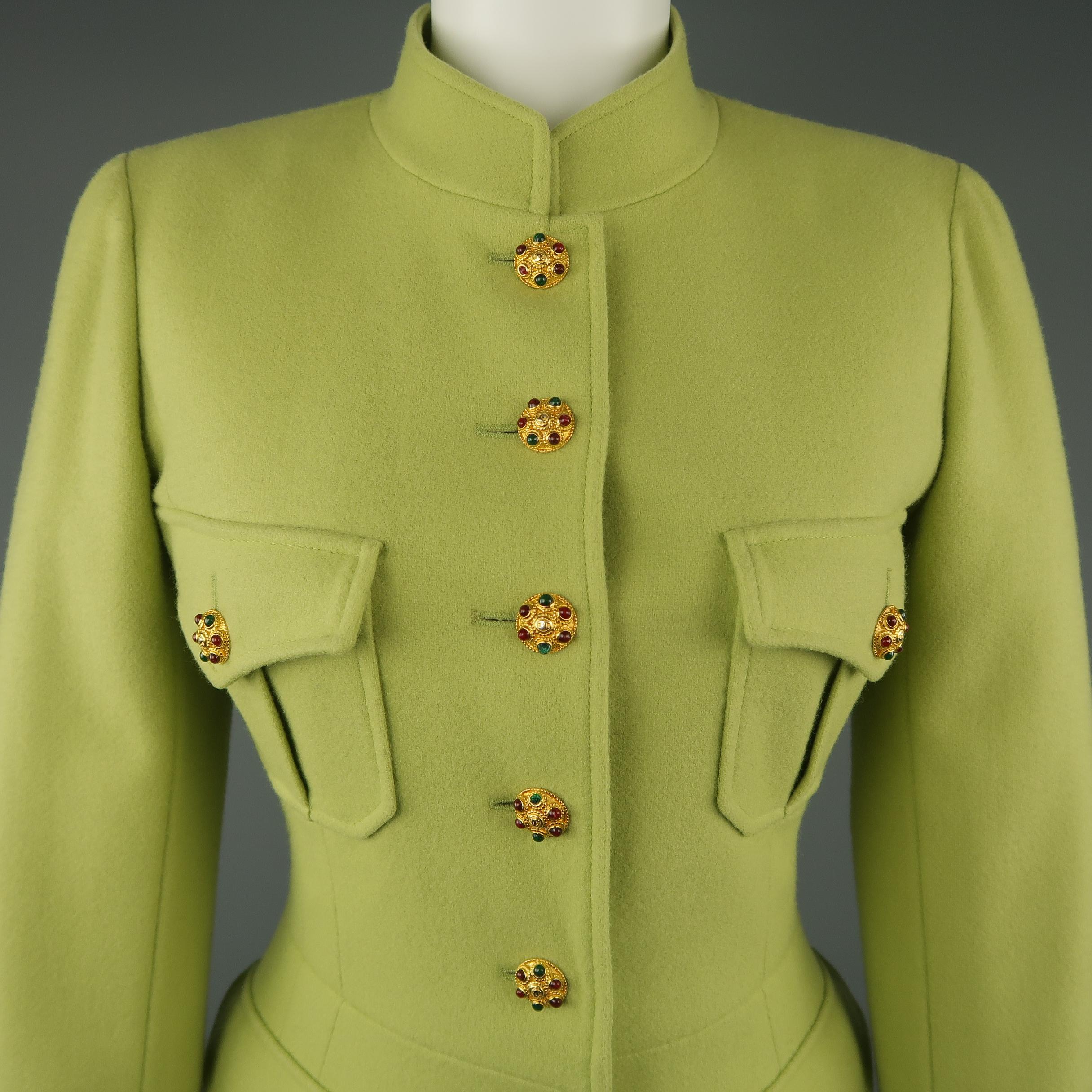 Vintage circa Fall Winter 1996 CHANEL BOUTIQUE military style jacket comes in light pistachio green wool with a stand up Nehru collar, four patch flap pockets, six button front, silk Camellia lining with chain weight, functional button cuffs and