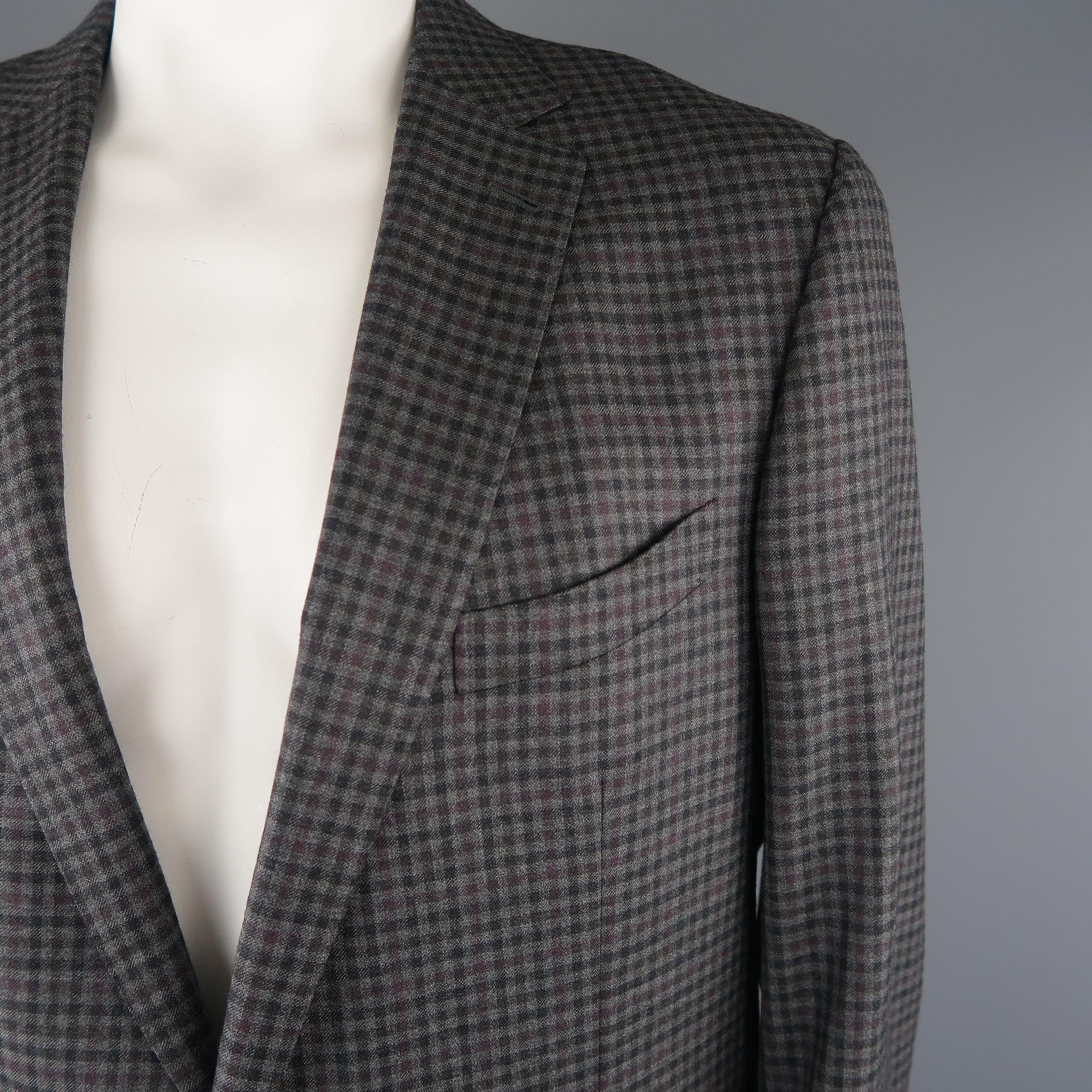 ERMENEGILDO ZEGNA sport coat come in dark gray tone in checkered wool material, featuring notch lapel, 2 buttons on the closure, single breasted, flap pockets, and double vent on the hem. Made in Italy.
 
Excellent Pre-Owned Condition.
Marked: 58 R
