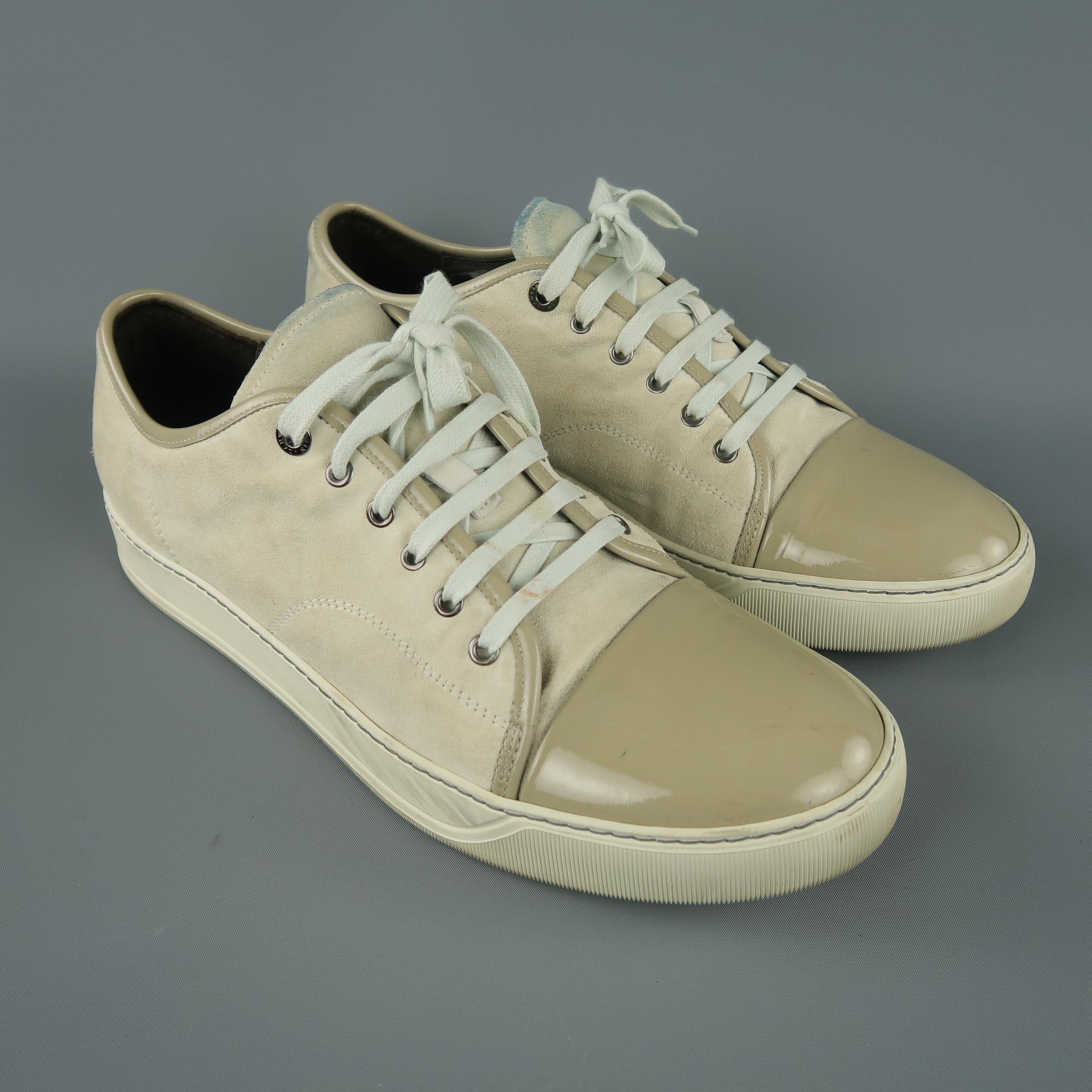 LANVIN soft ivory suede low-top sneakers are styled with a patent leather cap toe. As-Is. Made in Portugal.
 
Very good Pre-Owned Condition.
Marked: Lanvin UK 12
 
Outsole: 13 x 3 in