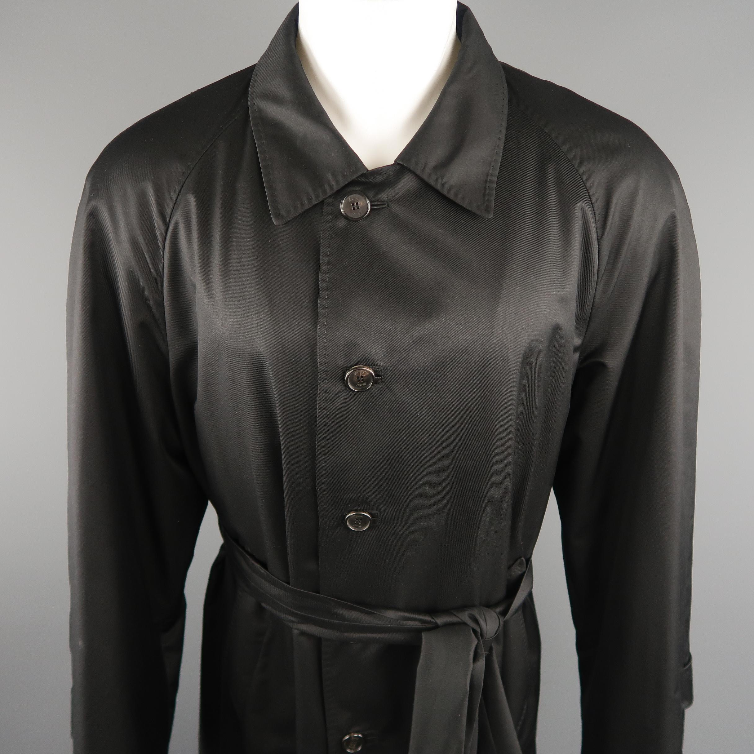 WILKES BASHFORD by BRIONI long trenchcoat comes in a black solid silk, with slit pockets, leather buttonholes and belt. Made in Italy.
 
Excellent Pre-Owned Condition.
Marked: 48 IT
 
Measurements:
 
Shoulder: 17.5 in.
Chest: 48 in.
Sleeve: 27
