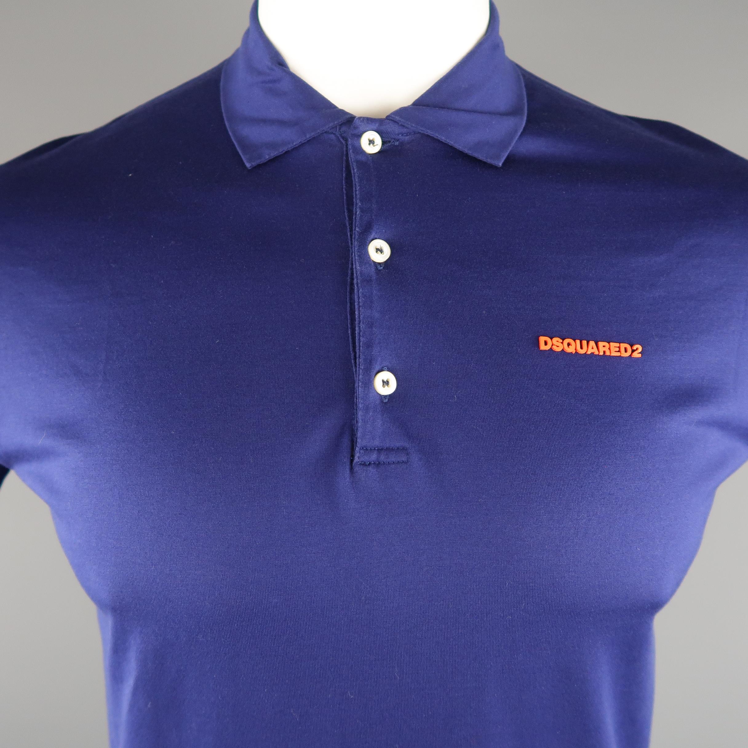 DSQUARED2 POLO shirt comes in a navy solid pique cotton, with contrast orange logo and buttoned. Made in Italy.
 
Excellent Pre-Owned Condition.
Marked: L
 
Measurements:
 
Shoulder: 17 in.
Chest: 41 in.
Sleeve: 8 in.
Length: 26 in.