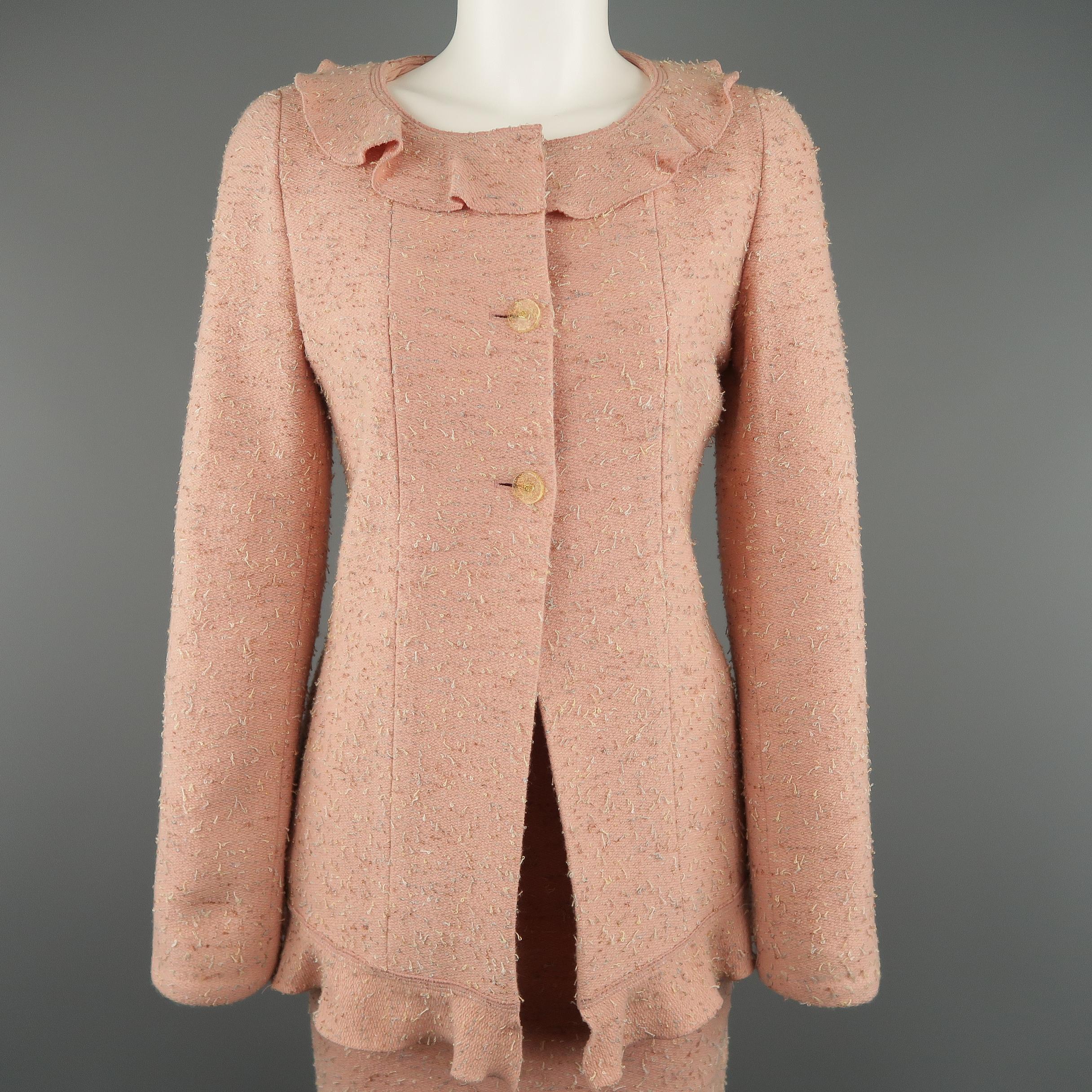 Vintage CHANEL Autumn Winter 1999 Collection suit comes in a muted pink wool blend textured tweed and includes a mid length jacket with a round collar, ruffle trim, and  three half button closure with a matching pencil skirt. Made in France.
