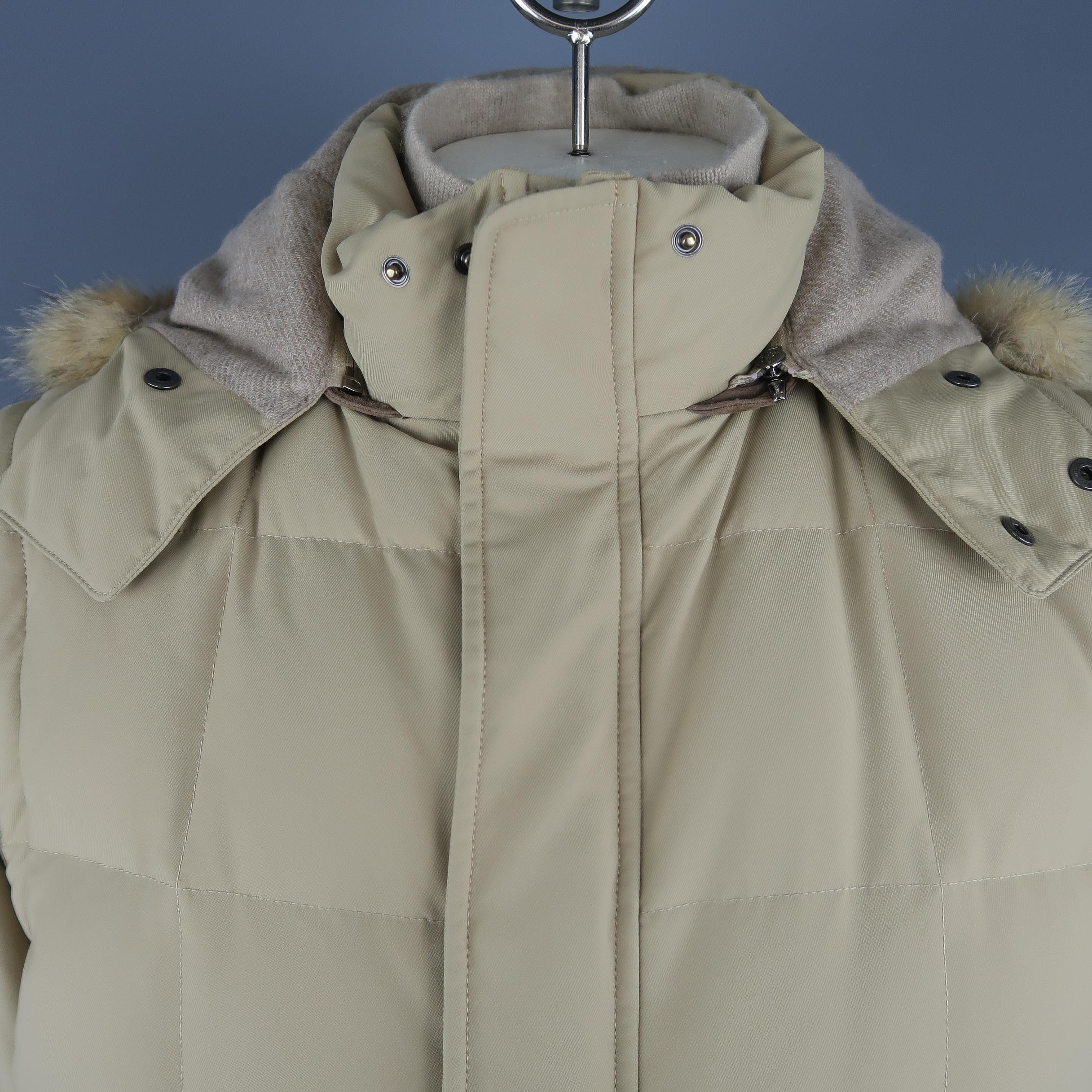 LORO PIANA puff jacket comes in khaki down filled quilted twill with slanted pockets, double zip snap placket front, high collar with internal cashmere removable liner, zip off sleeves, and detachable cashmere lined fox fur trimmed hood. Made in