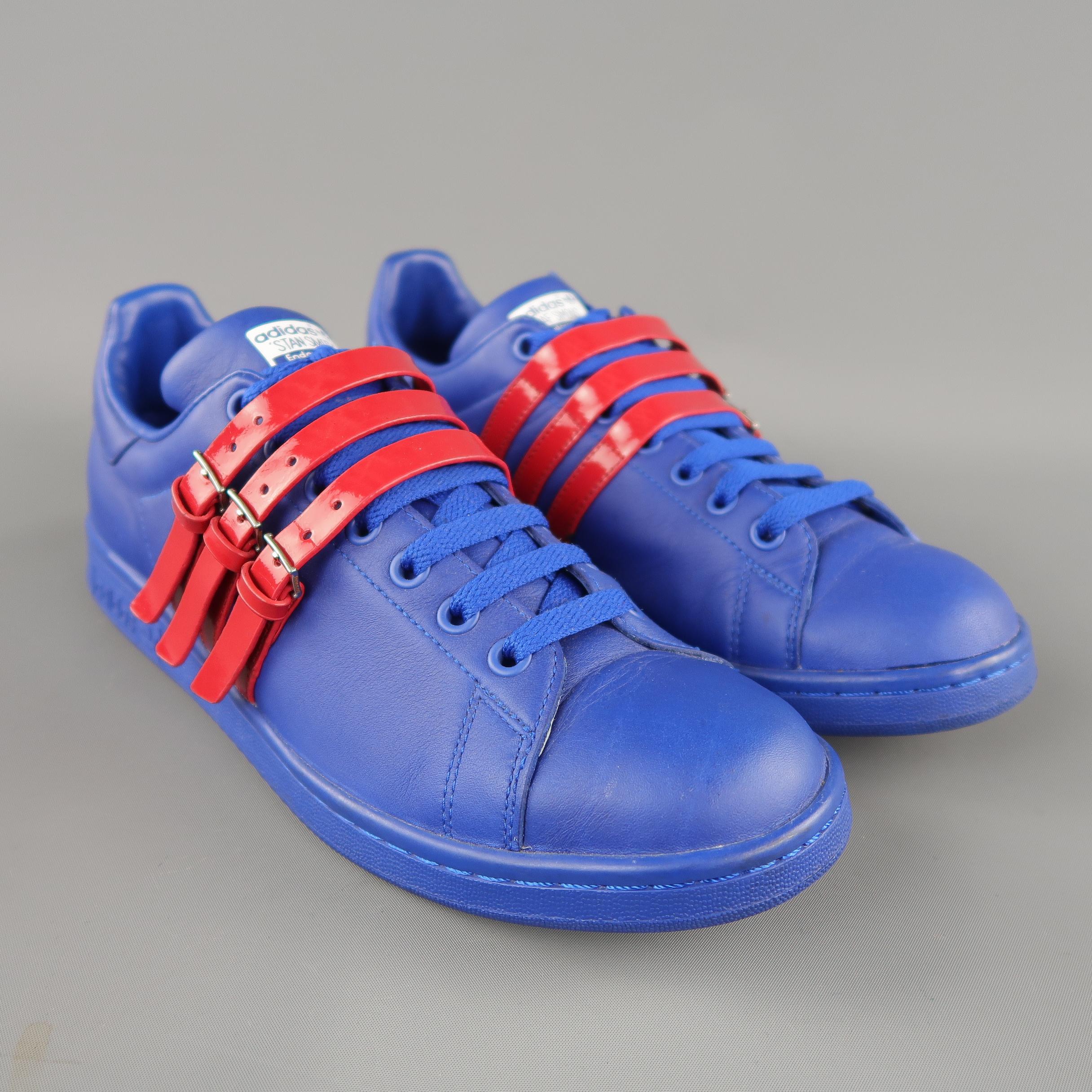 RAF SIMONS ADIDAS Stan Smith sneakers come in royal blue leather with red patent leather straps. With box.
 
Excellent Pre-Owned Condition.
Marked: 9.5
 
Outsole: 11.5 x 4 in.