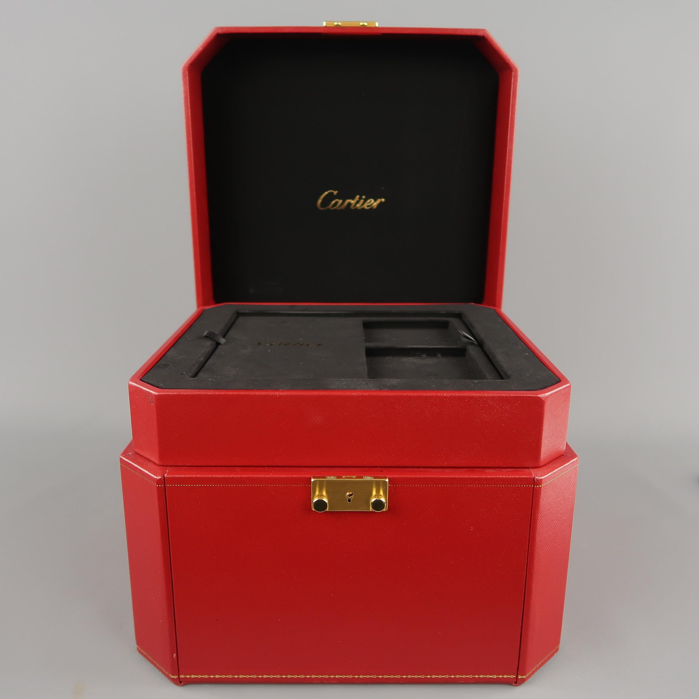Vintage CARTIER jewelry box comes in signature red textured coated canvas in an octagonal cube shape, top handle, gold foil trim, gold tone metal lock closure with key, and black rubberized multi-compartment storage drawers. Wear consistant with