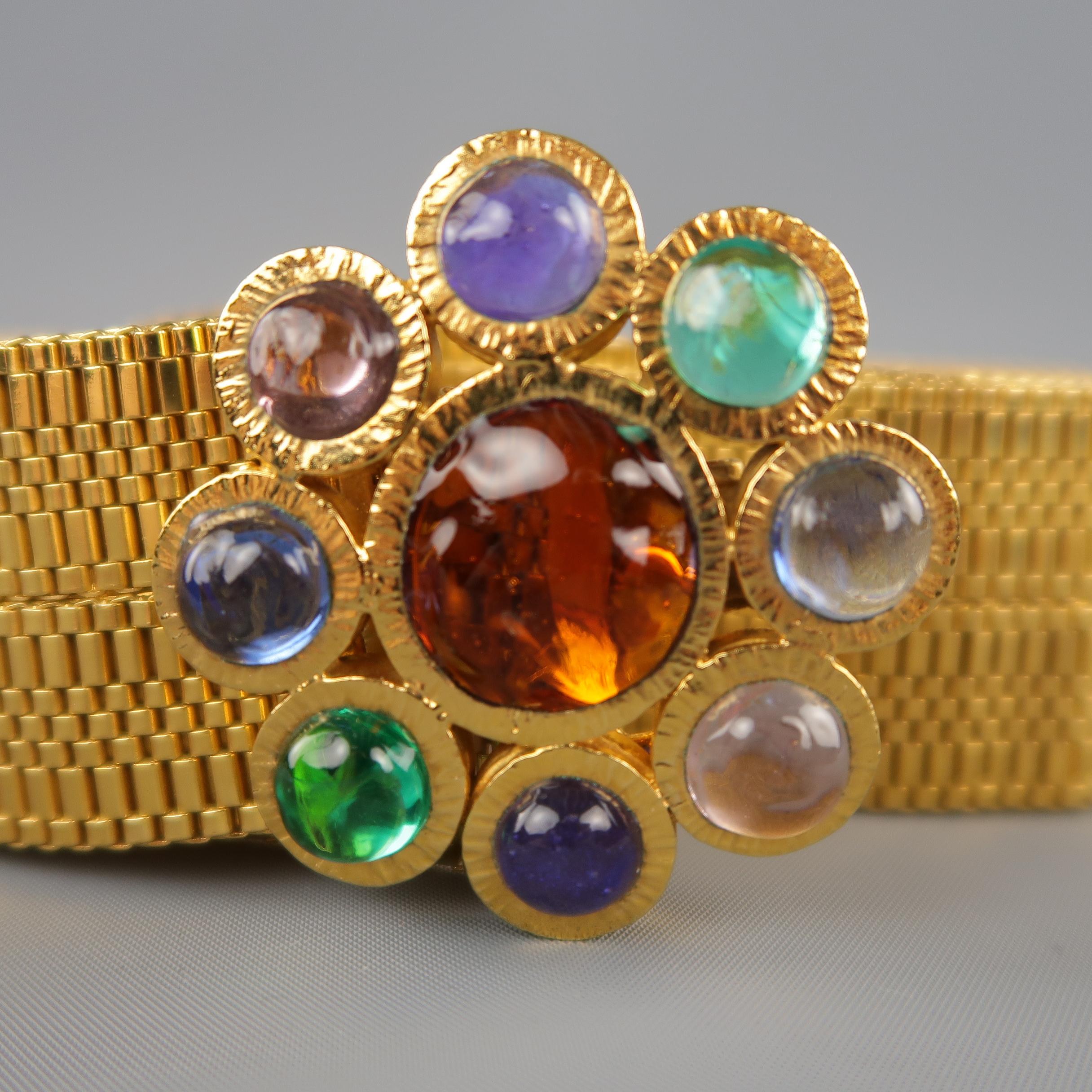 Vintage CHANEL from 1997 statement belt comes in gold tone metal with a metal woven strap and Gripoix Byzantine Flower adorned with green, purple, pink, blue, and amber stones. Made in France.
 
Excellent Pre-Owned Condition.
Marked: A '96
 
Length: