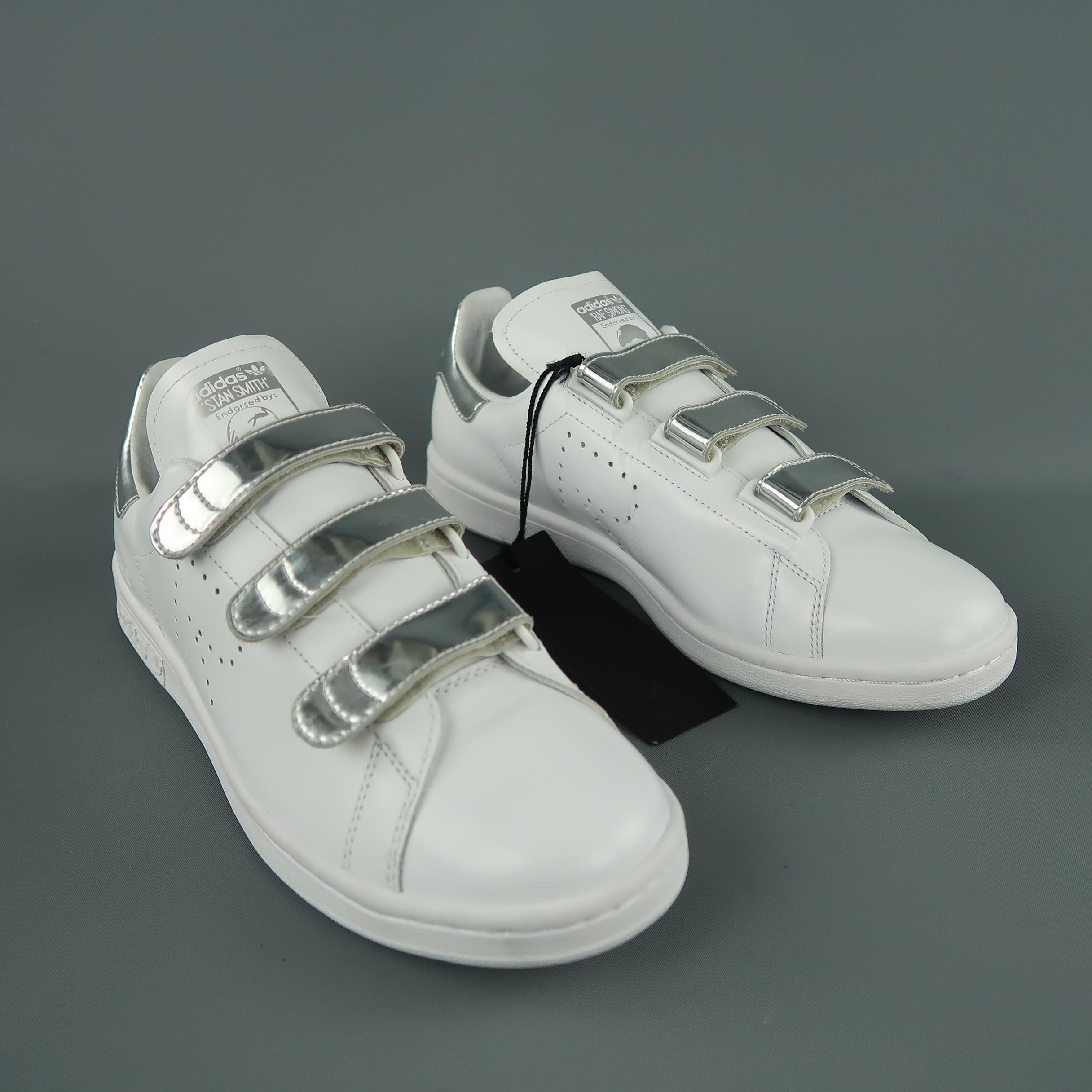 Adidas by RAF SIMONS  sneakers come in white solid leader, with silver strap closure. With Box.
 
New with Tags.
Marked: 8.5 US
 
Measurements:
Outsole: 11.5 x 2.5 in.