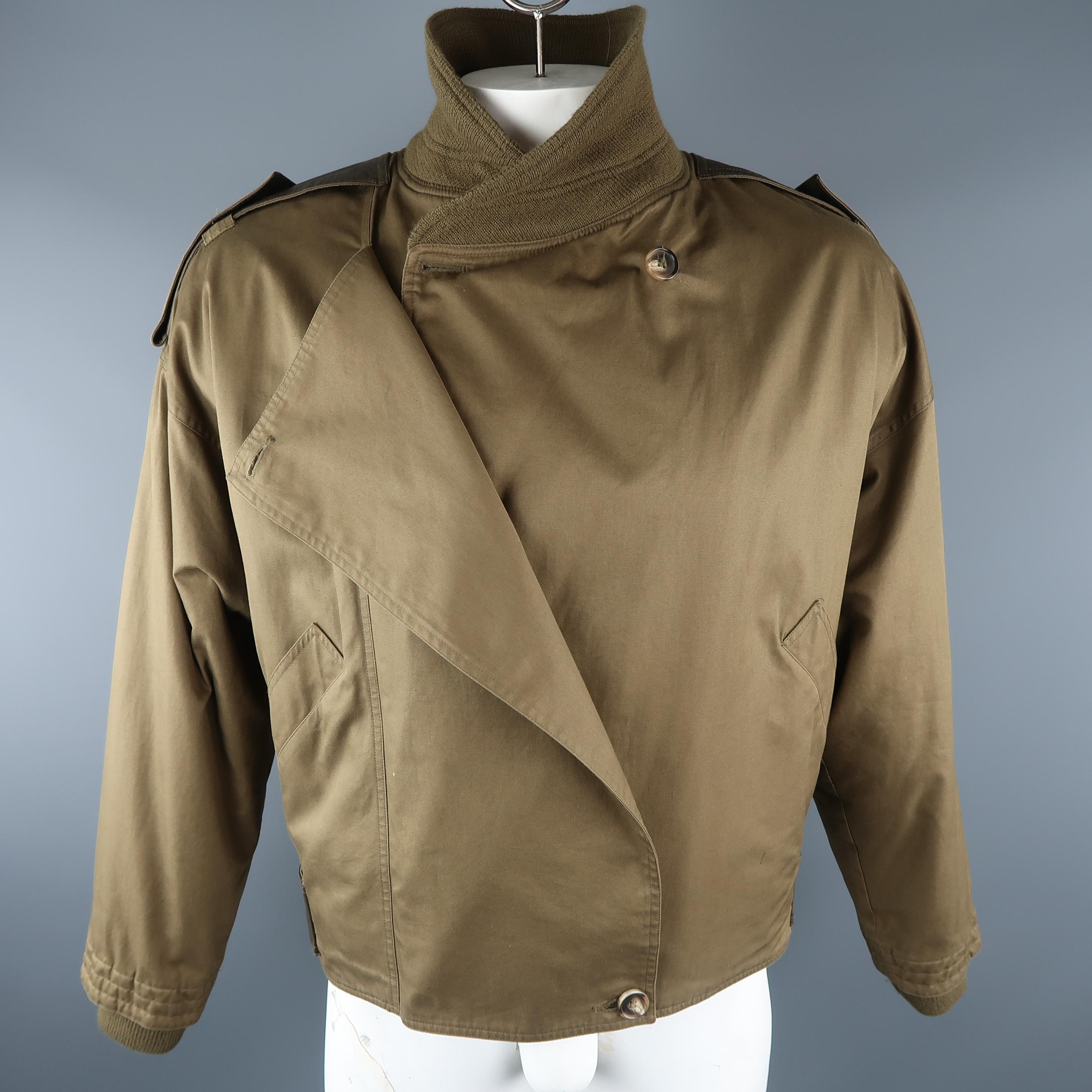 Vintage GIANNI VERSACE cropped jacket come in olive solid cotton with leather trim, buttoned closure and ribbed collar and cuffs. Made in Italy.
 
Excellent Pre-Owned Condition.
Marked: 52 IT
 
Measurements:
 
Shoulder: 17.5  in.
Chest: 54 