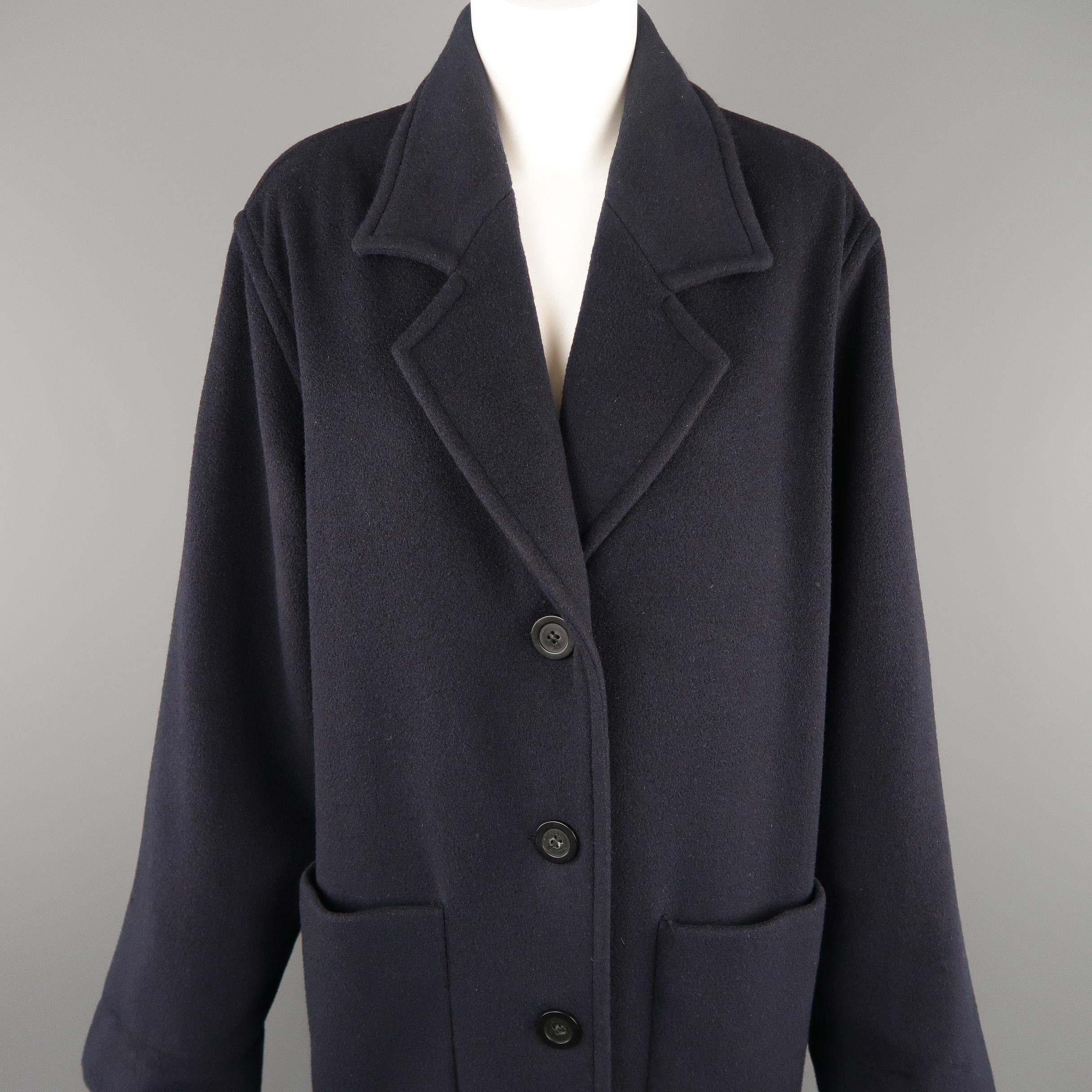 TSE overcoat comes in navy blue cashmere with a pointed lapel, single breasted four button closure, and patch pockets. Made in Italy.
 
Excellent Pre-Owned Condition.
Marked: M
 
Measurements:
 

    Shoulder: 18 in.
    Bust: 48 in.
    Waist: 48