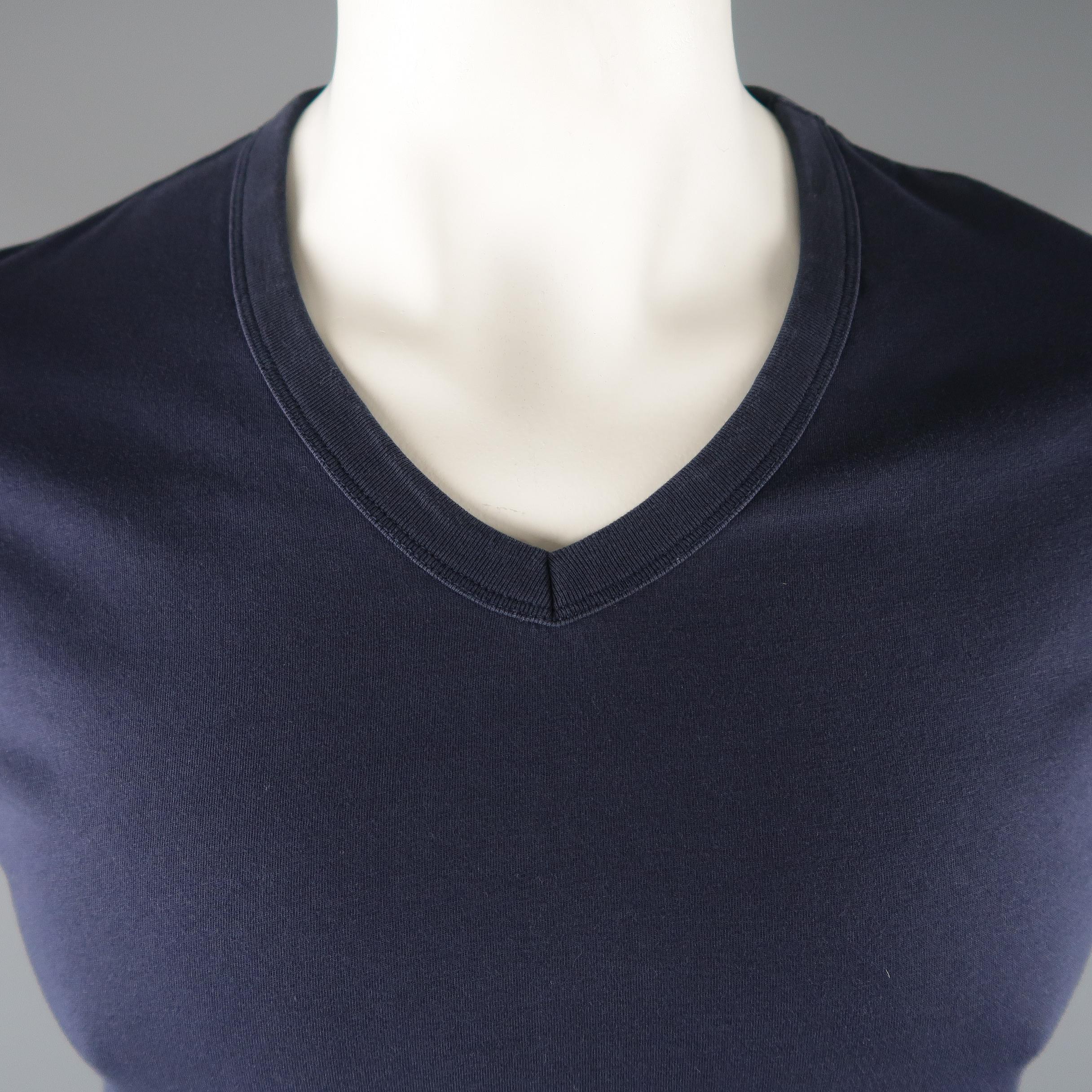 MAISON MARTIN MARGIELA T-shirt come in a navy solid cotton material, with a V-neck.
 
Excellent Pre-Owned Condition.
Marked: 50 IT
 
Measurements:
 
Shoulder: 16  in.  
Chest: 40  in.
Sleeve: 8.5  in.
Length: 26  in.