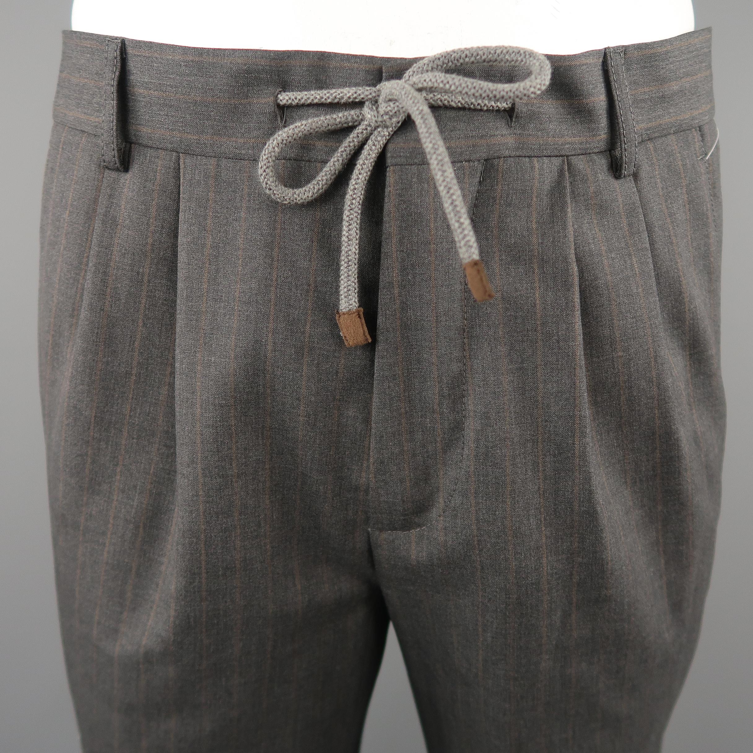 BRUNELLO CUCINELI dress pants come in gray tone in striped wool material, with drawstring and pleats, seam and flap pockets and zip fly. 

Made in Italy. 
Excellent  Pre-Owned Condition.
Marked: 48 IT
 
Measurements:
 
Waist:  34  in.
Rise: 12.5 