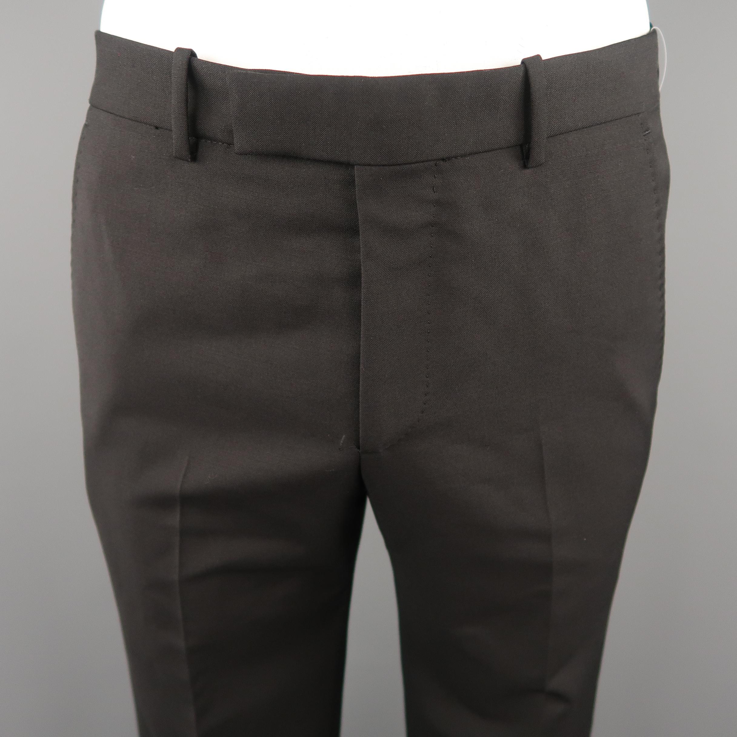 ALEXANDER MCQUEEN dress pants come in black solid wool material, featuring flat front, front tab, zip fly, seam and slit pockets. 
Made in Italy.
 
Excellent  Pre-Owned Condition.
Marked: 50 IT
 
Measurements:
 
Waist:  35  in.
Rise: 12  in.
Inseam: