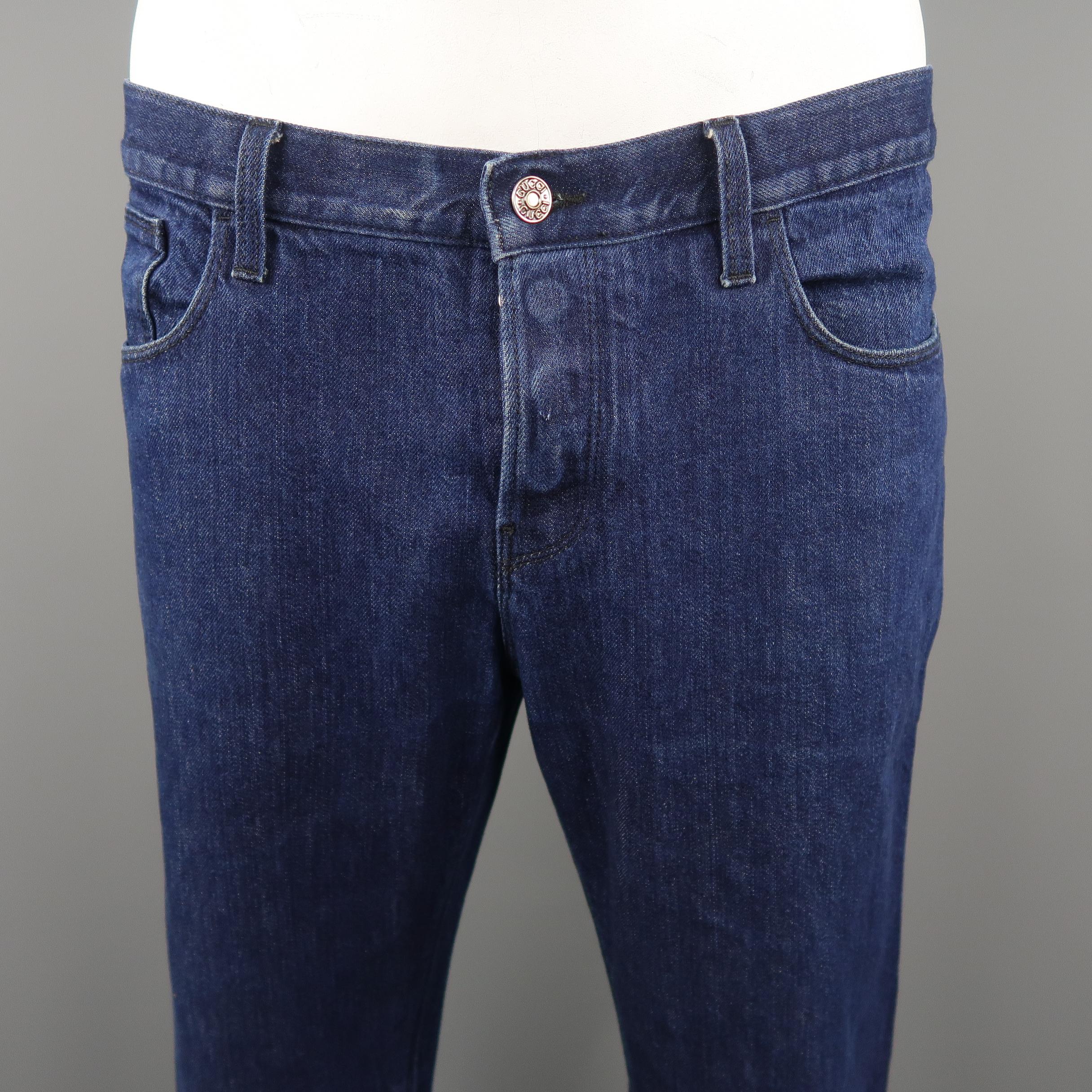 GUCCI jeans come in indigo solid denim material, button fly which feature a black logo on the back pocket. Very light signs of wear throughout. 
Made in Italy.
 
Excellent  Pre-Owned Condition.
Marked: 54 IT
 
Measurements:
 
Waist:  38  in.
Rise: