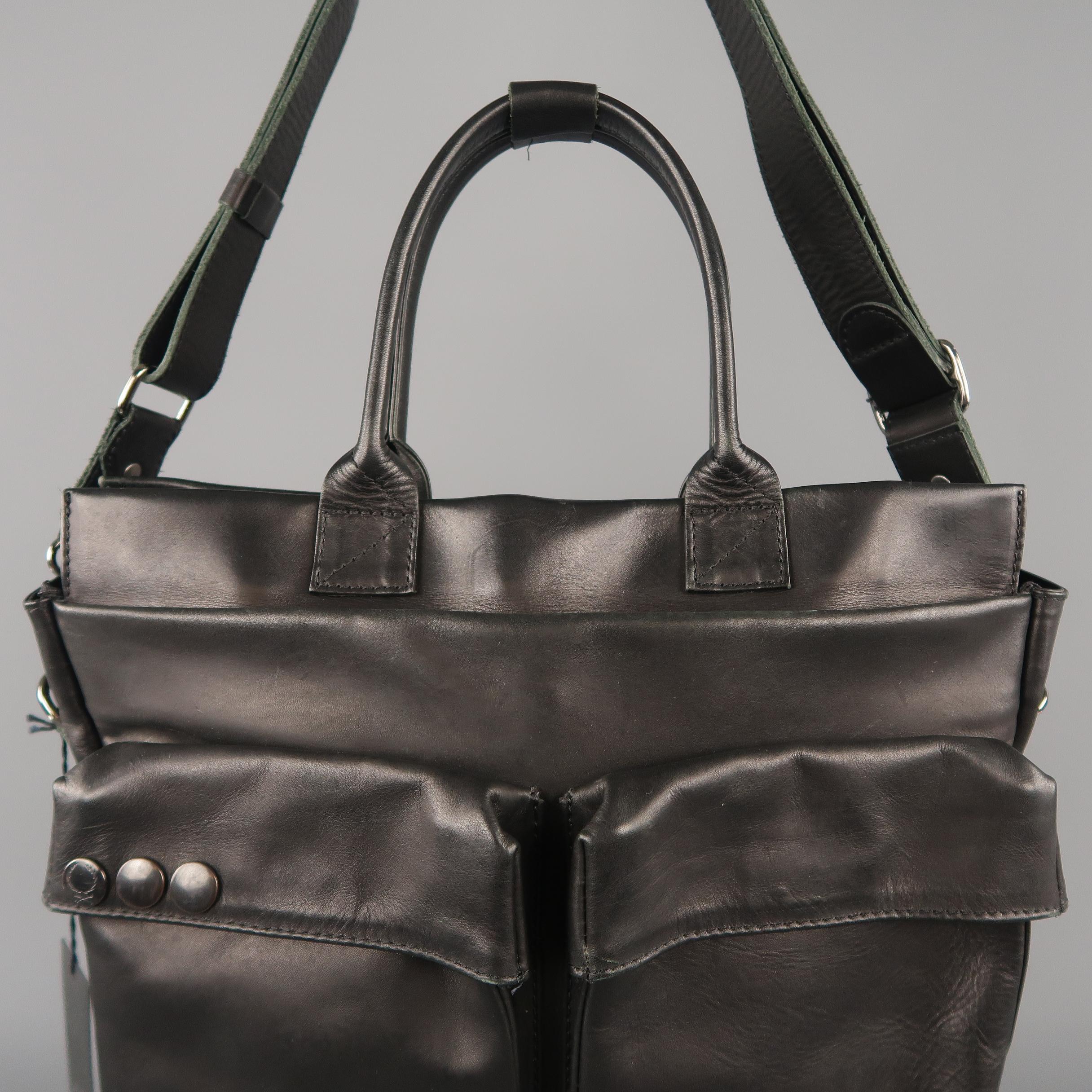 SURFACE TO AIR cargo bag in a soft black leather featuring  a front double cargo pocket, top handle, shoulder strap, dark silver tone metallic hardware, and double compartment storage. Retail price $539.00
 
New with Tags.
 
Measurements:
 
Length: