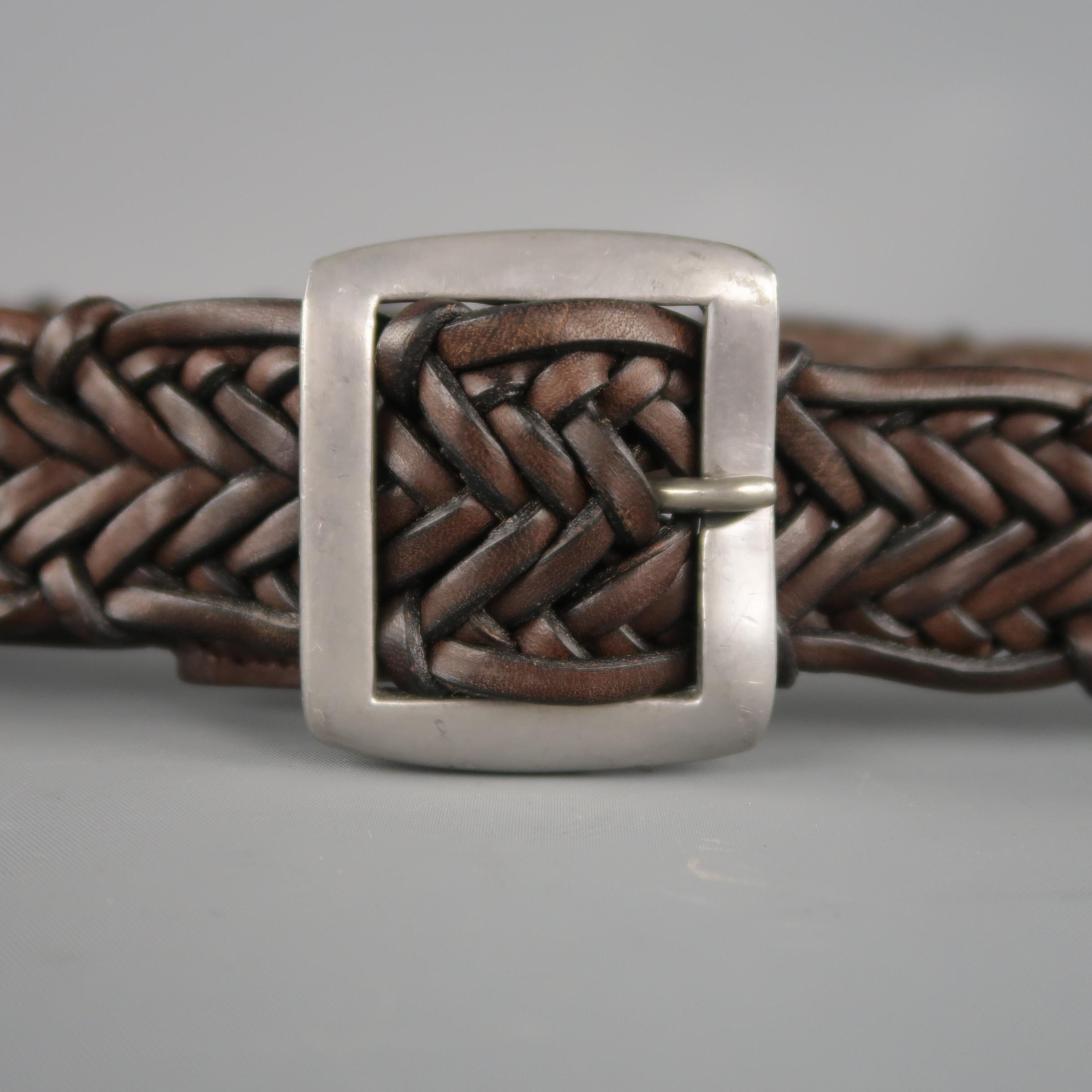 JOHN VARVATOS  belt come in a brown leather braided material, with a silver tone aged metal buckle. Made in England.
 
Excellent Pre-Owned Condition.
Marked M
 
Length: 42.5  in.
Width: 1.5  in.
Fits: up to 38  in.