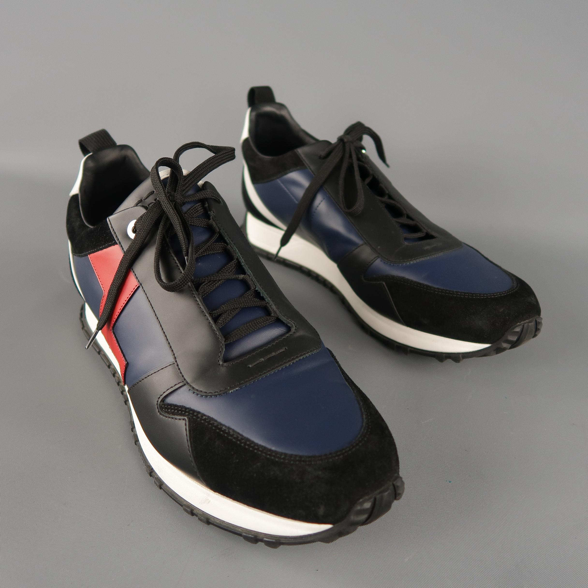 FENDI lightning bolt applique sneakers are in black and navy color block leather, with a brand embossed tongue, suede trim, lace up. With Box. Made in Italy. Retail price: 750.00
 
Excellent Pre-Owned Condition.
Marked: 9 UK
 
Outsole: 12.5  x 3 in.
