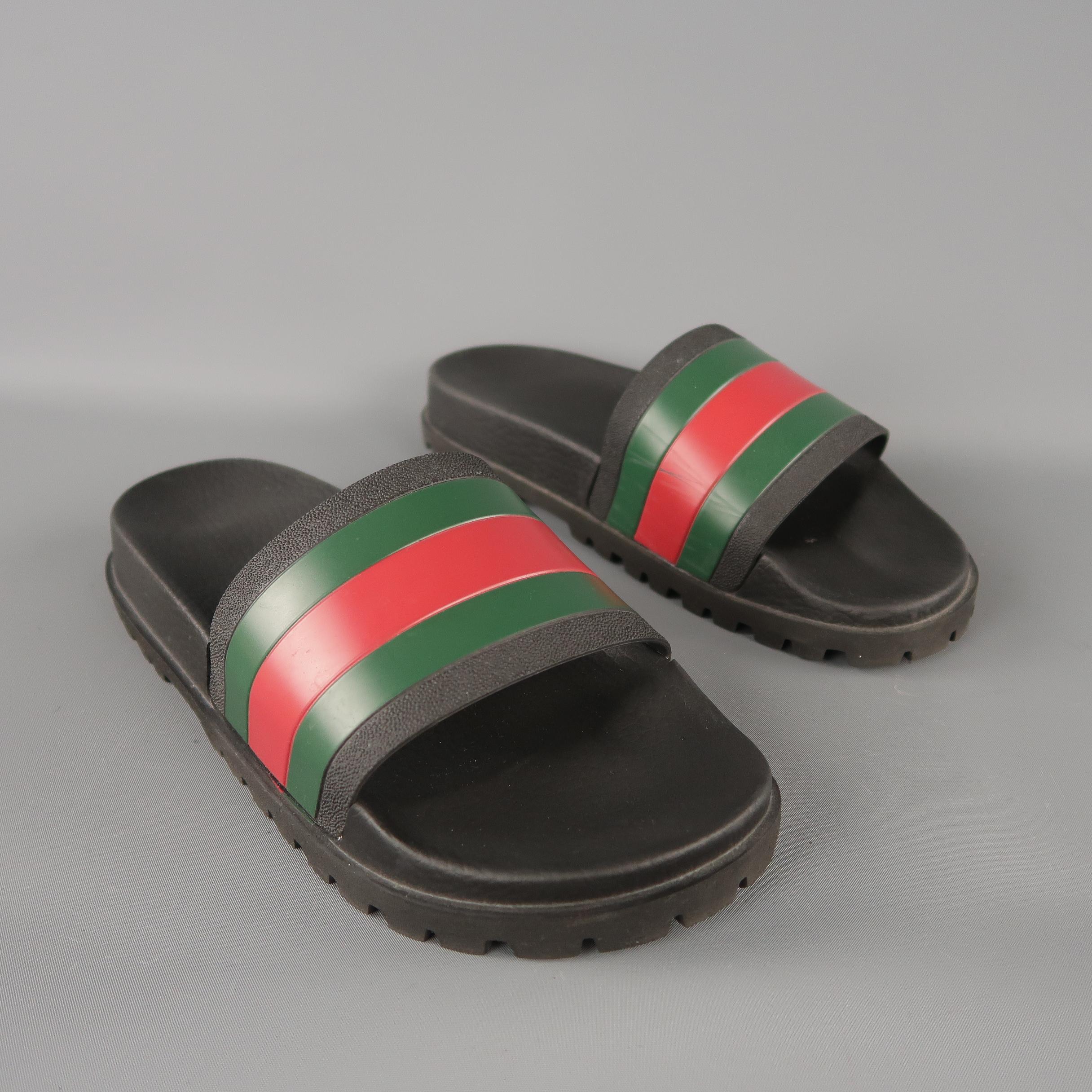 GUCCI web slide sandals are in black rubber material, with the classical brand stripes,  a molded rubber footbed and a rubber sole. Minor wear. Made in Italy.
 
Excellent Pre-Owned Condition.
Marked: 8 UK
 
Outsole: 11 x 3.5  in.