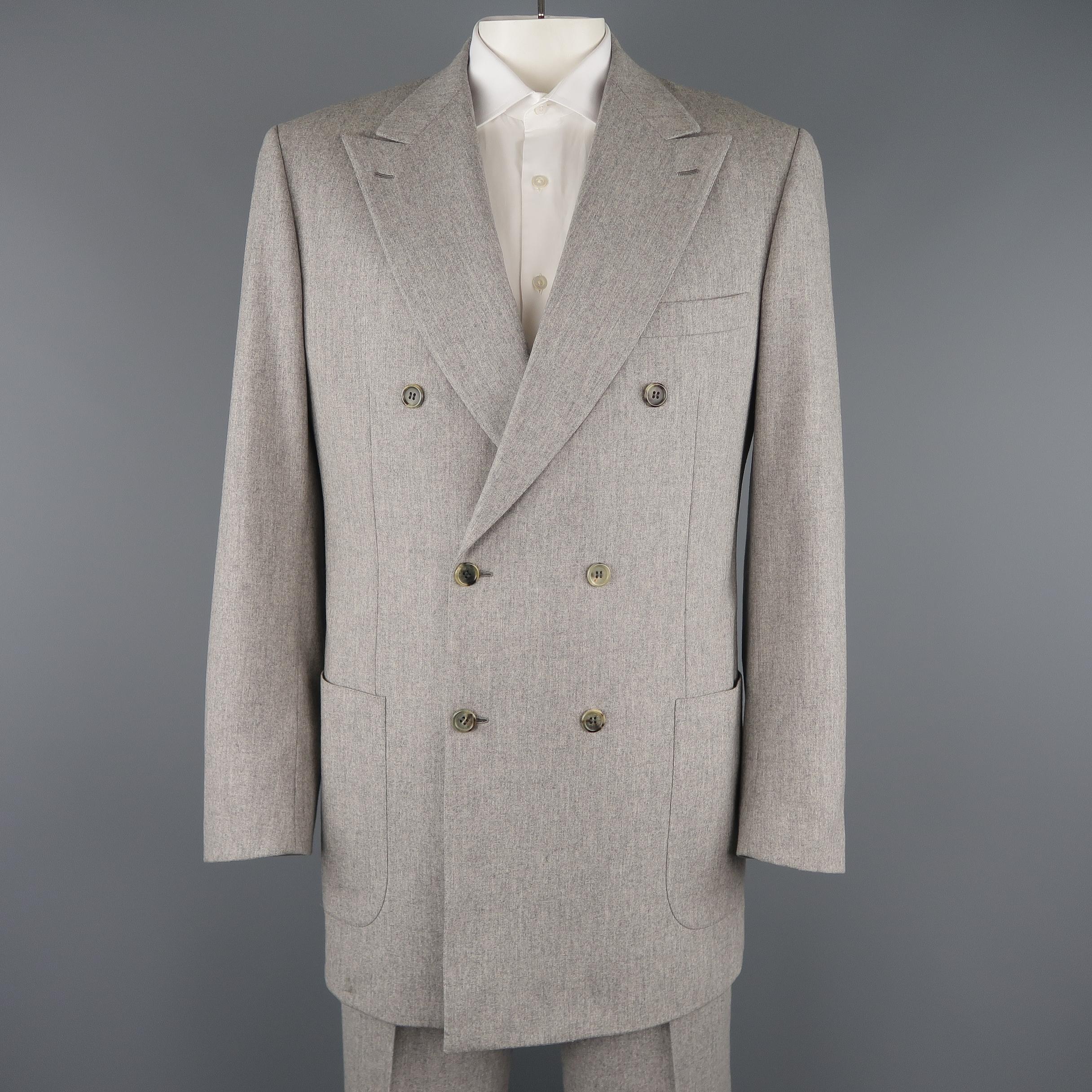 BRIONI suit comes in light heather gray wool and includes a double breasted, peak lapel sport coat with functional button cuffs and gorgeous paisley liner with matching flat front, cuffed hem trousers. 

Made in Italy. 
Excellent Pre-Owned