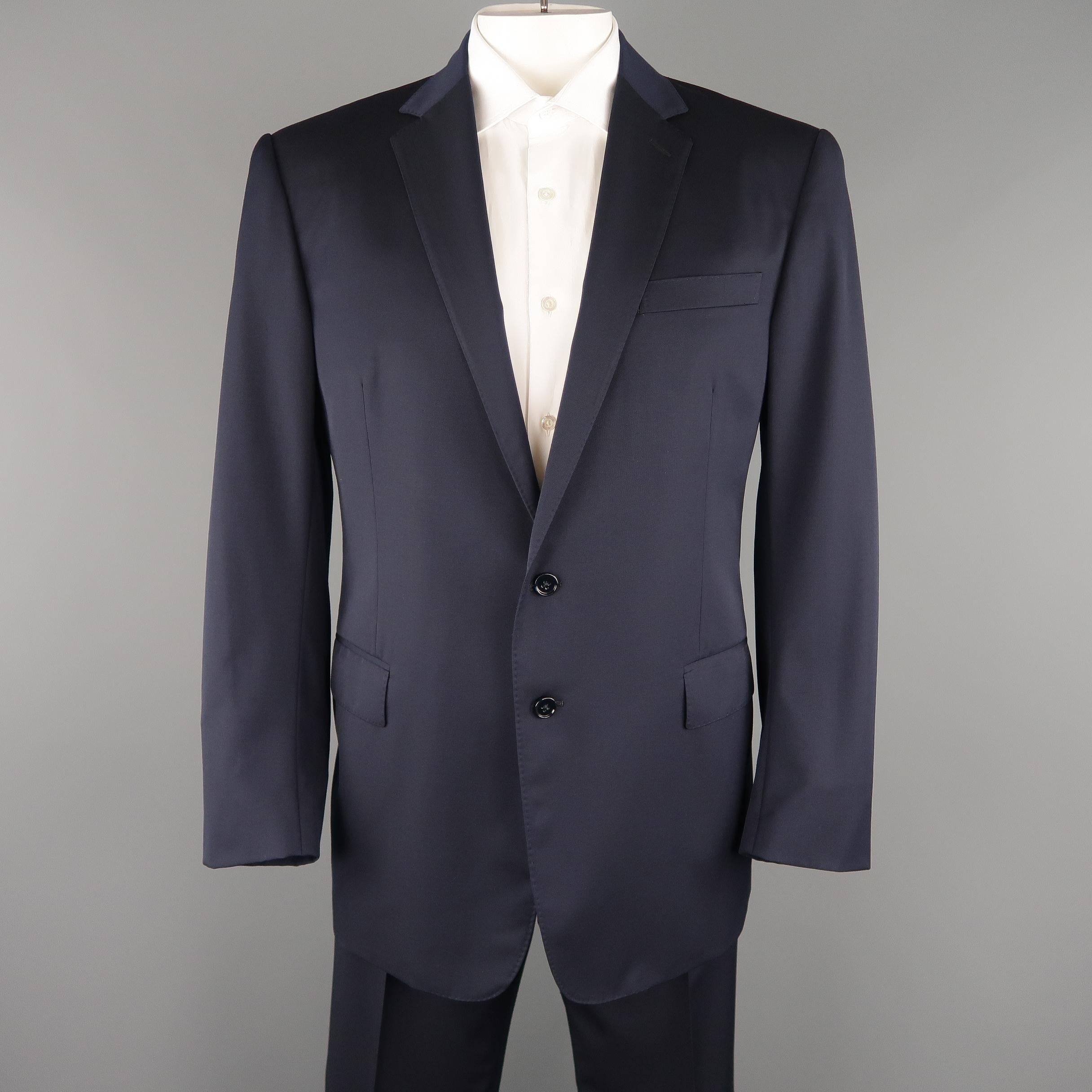RALPH LAUREN BLACK LABEL suit comes in navy blue wool twill, lined in silk and features a single breasted, two button, notch lapel sport coat with top stitching and functional button cuffs with matching flay front trousers. 

Made in Italy.