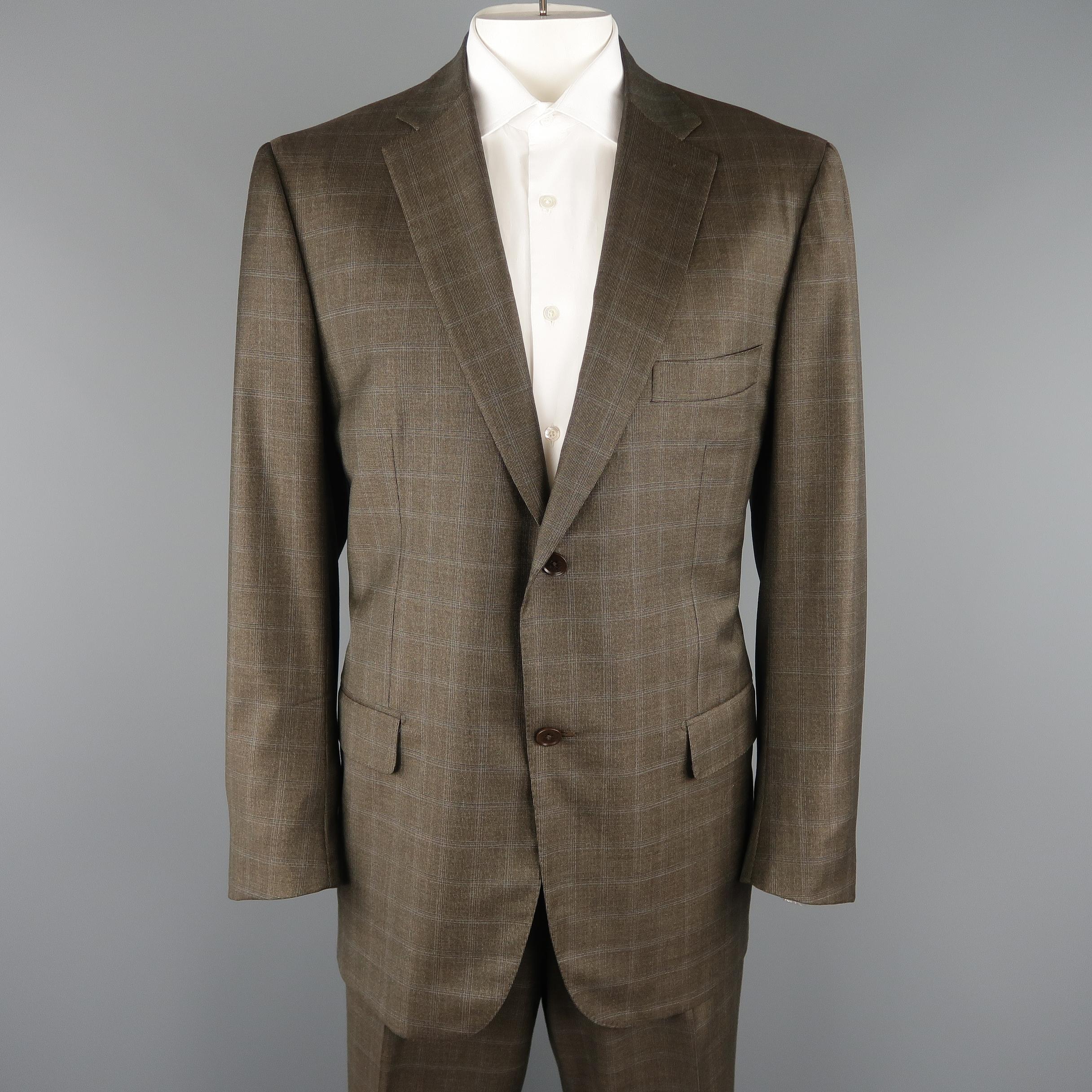 ISAIA two piece suit comes in brown windowpane wool and includes a single breasted two button, notch lapel, sport coat with functional button cuffs with matching flat front trousers. 

Made in Italy.
Original Price: $3,795.00
Excellent Pre-Owned