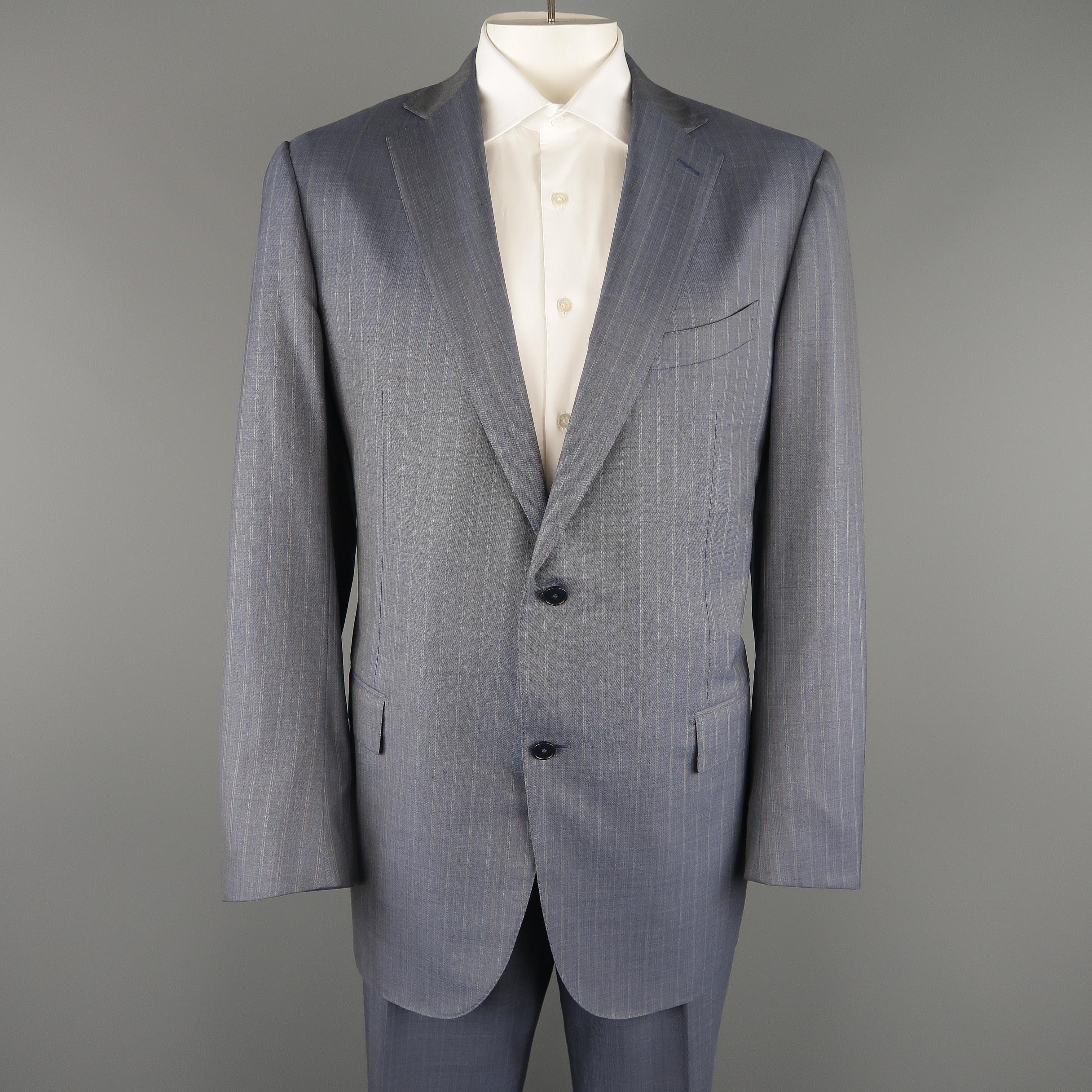 ERMENEGILDO ZEGNA two piece suit comes in muted blue pinstriped wool and includes a single breasted, notch lapel, two button sport coat with functional button cuffs and silk lining with matching flat front trousers. 

Made in Switzerland. 
Excellent