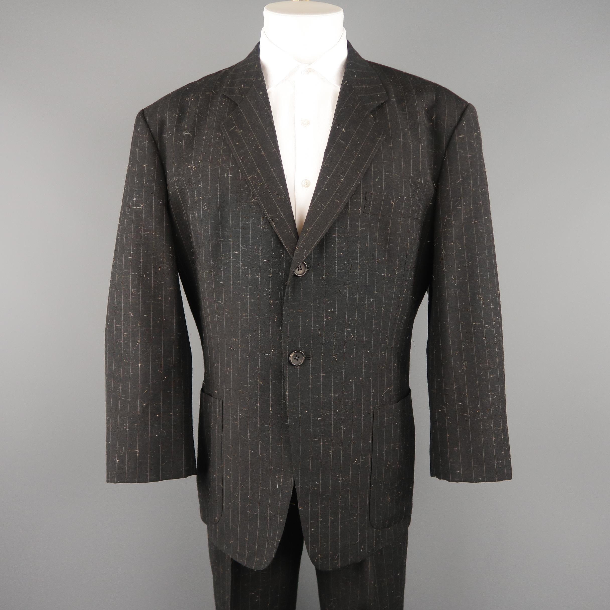Rare vintage YOHJI YAMAMOTO POUR HOMME  suit includes an oversized, single breasted notch lapel sport coat in a unique charcoal pinstripe brown hair textured wool blend and matching flat front trousers. 

Made in Japan. 
Excellent Pre-Owned