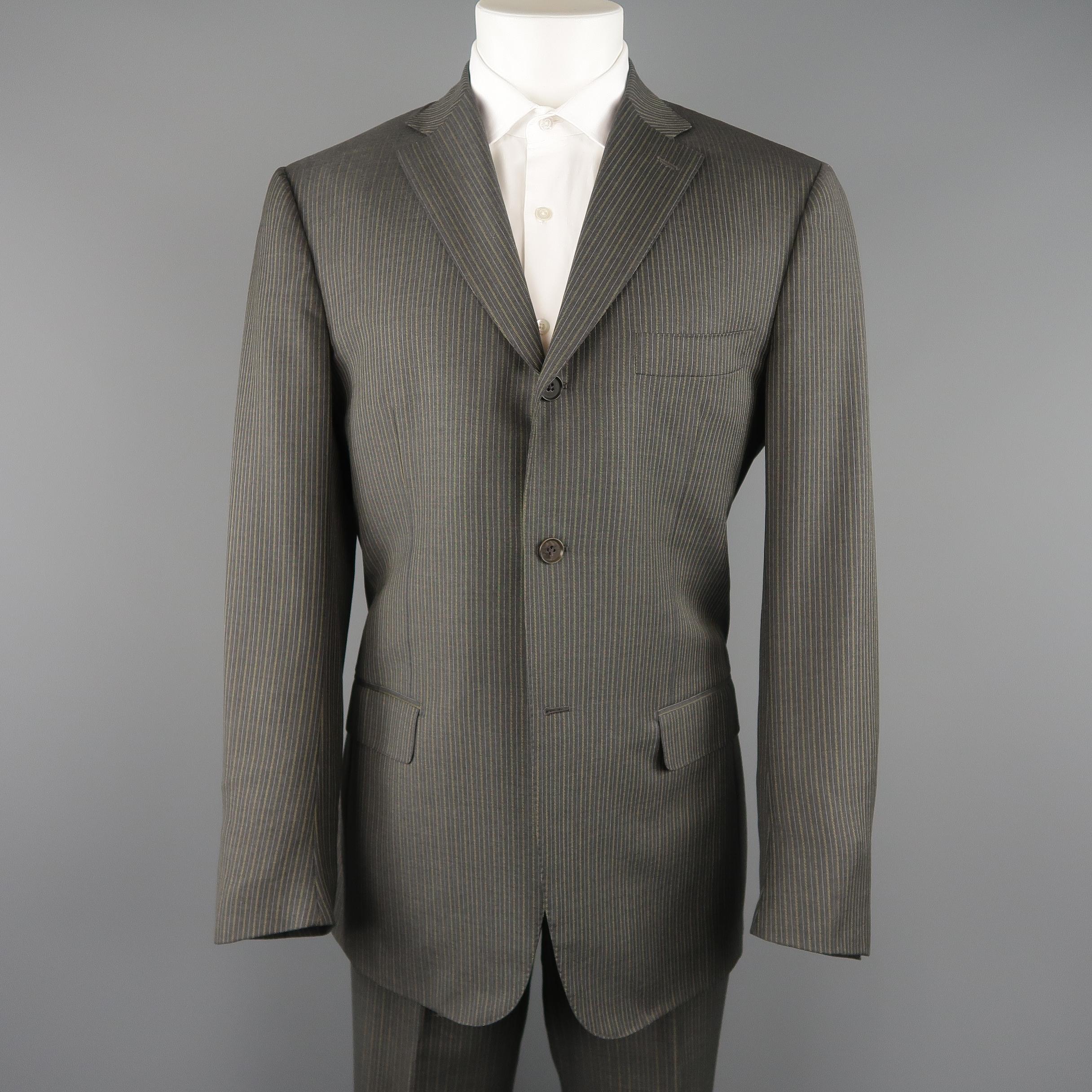 ISAIA two piece suit comes in dark gray wool with an all over golden beige pinstripe and includes a single breasted, three button, notch lapel sport coat and matching flat front, cuffed trousers. A couple marks on pants. As-is. 

Made in Italy.