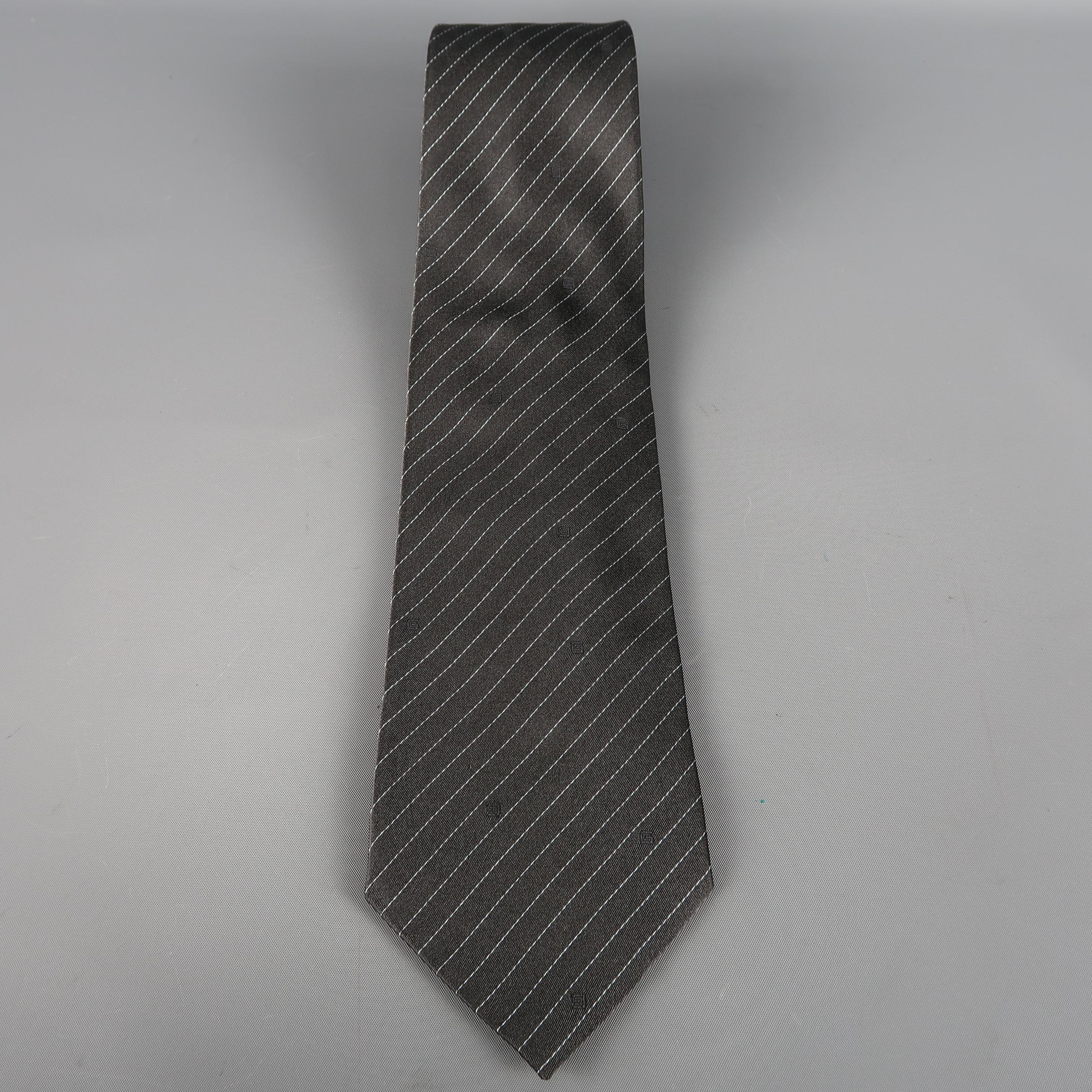 GUCCI tie come in dark gray silk  with all over diagonal silver stripes.  Small Gucci Logos (not stains). Made in Italy.
 
Excellent Pre-Owned Condition.
 
Width: 4 in.