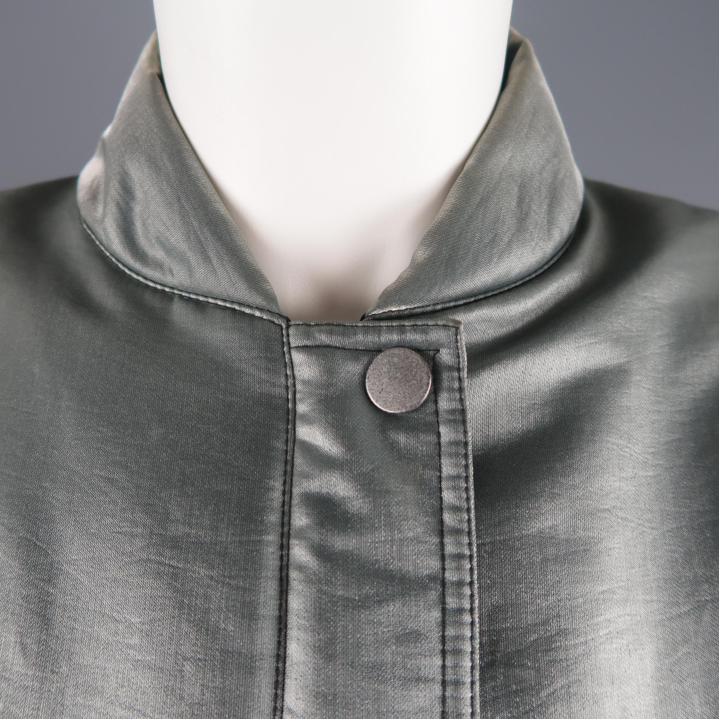 Vintage STATE OF CLAUDE MONTANA cropped bomber jacket comes in metallic teal gray taffeta with a hidden snap placket zip closure, baseball collar, slanted pockets, and elastic waistband and cuffs. Minor wear. 

Made in Italy. 
Good Pre-Owned
