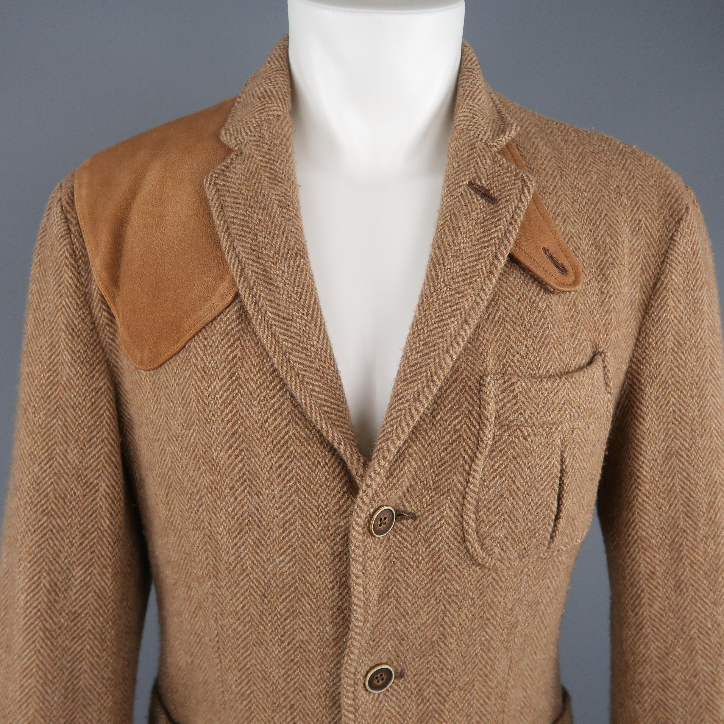 POLO RALPH LAUREN hunter jacket comes in tan herringbone tweed with a notch lapel, single breasted three button closure, pleated patch flap pockets, functional button cuffs, and suede patches. 
Good Pre-Owned Condition.

Marked: 38 R
