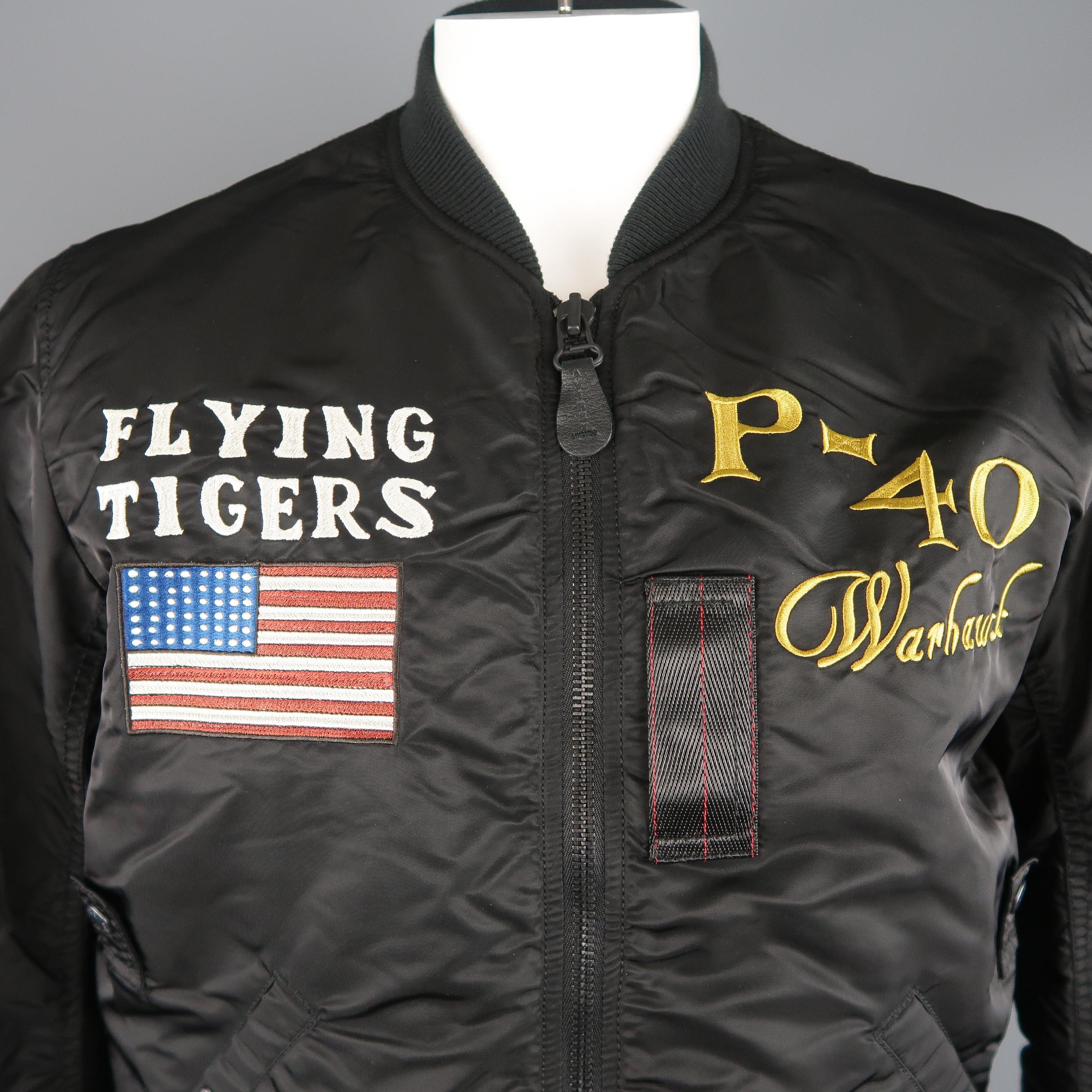 AVIREX flight bomber jacket comes in black nylon with a baseball collar, zip front, slanted pockets, arm pocket, tab details, and 'Flying Tigers' embroidery and patchwork.
 
Excellent Pre-Owned Condition.
Marked: XL
 
Measurements:
 
Shoulder: 19