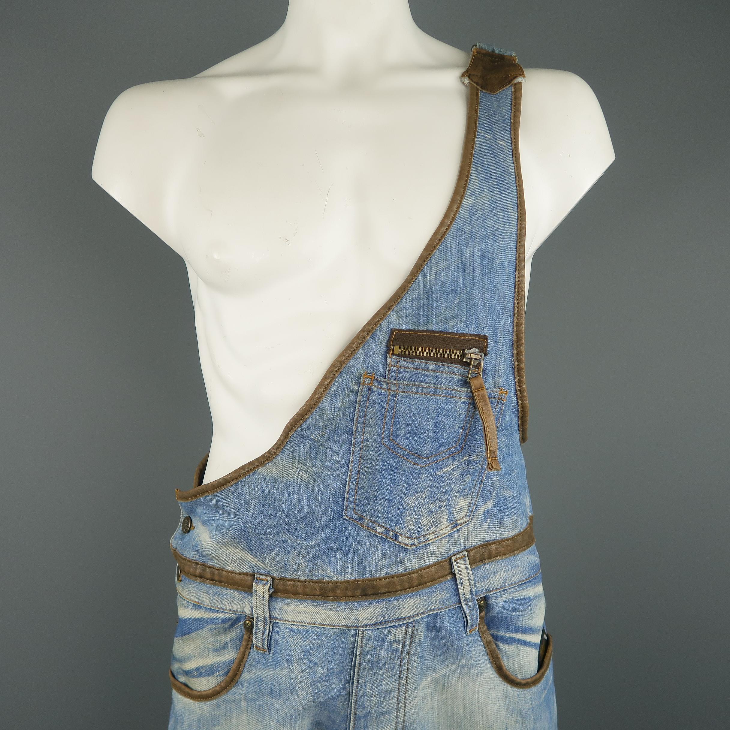 DSQUARED2 dungarees comes in light dirty washed denim with distressed details throughout, tan leather piping, patch flap cargo pockets, and single adjustable strap top. 

Made in Italy. 
Excellent Pre-Owned Condition.
Marked: 34
 
Measurements:
