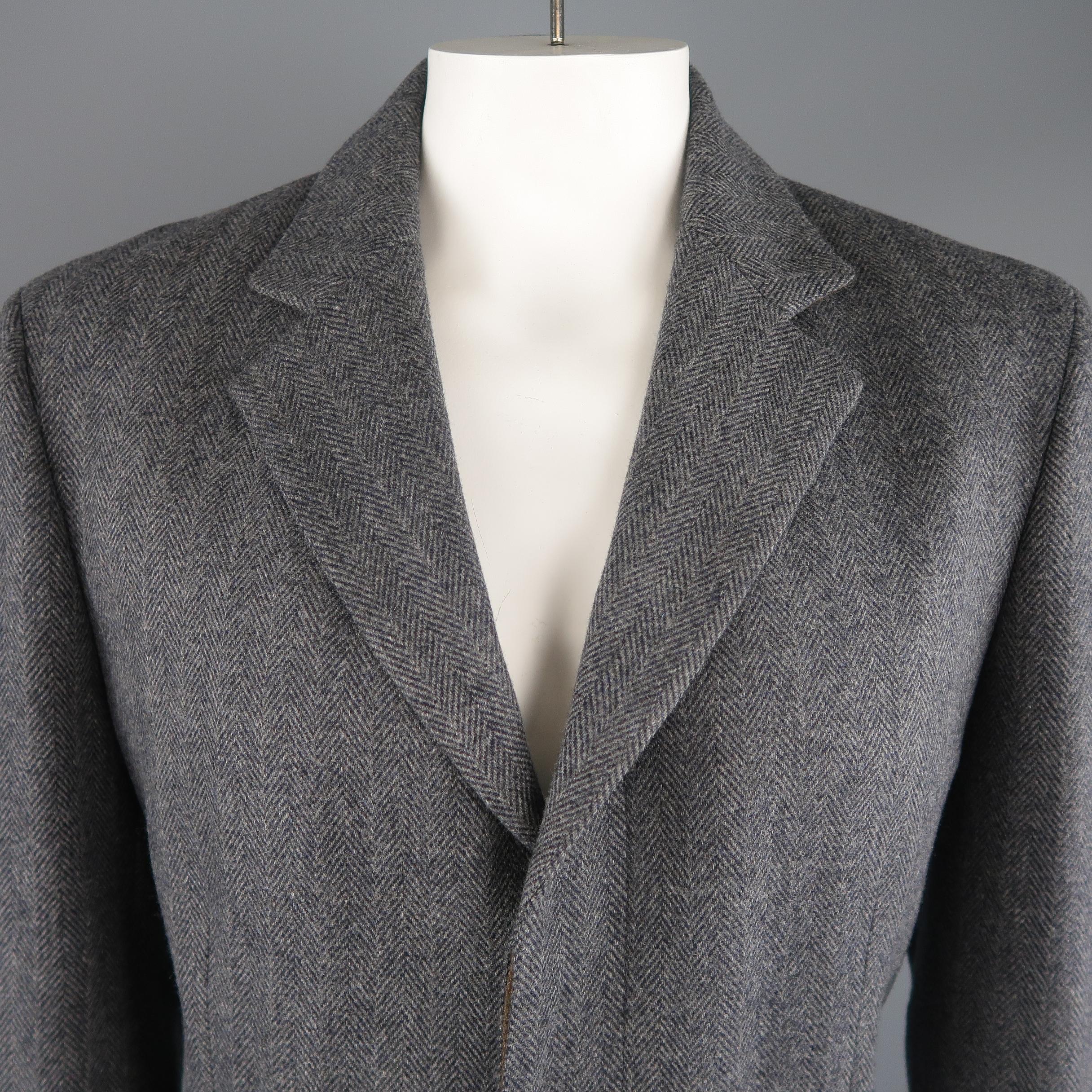 ELIE TAHARI over coat comes in herringbone wool cashmere blend fabric with a notch lapel, hidden placket button closure, flap pockets, and half liner. Slit stitches still intact. Never worn. Made in Italy.
 
Excellent Pre-Owned Condition.
Marked: L
