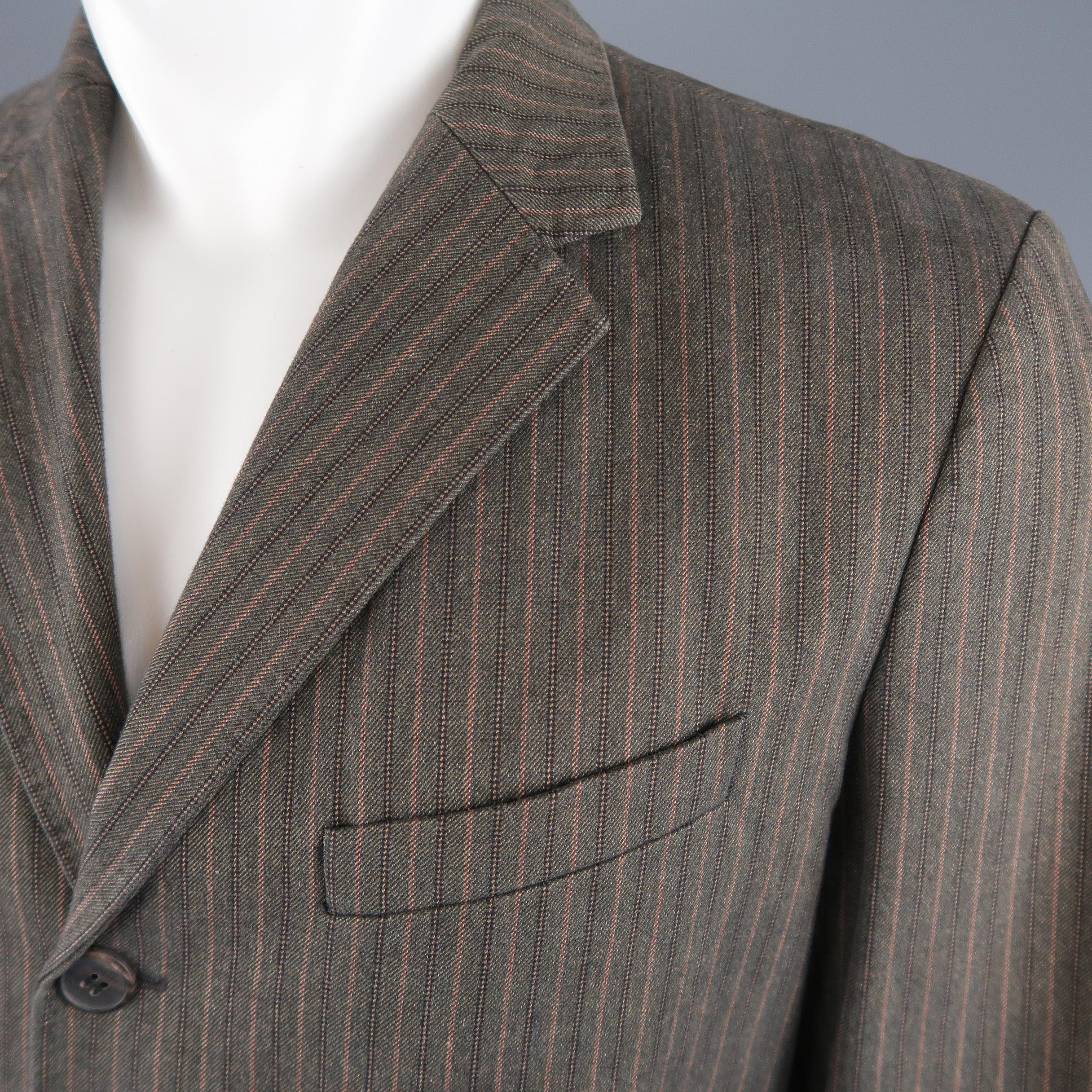 DRIES VAN NOTEN sport coat comes in taupe brown striped herringbone cotton with a notch lapel, three button single breasted front, and flap pockets. Made in Belgium.
 
Excellent Pre-Owned Condition.
Marked: IT 48
 
Measurements:
 
Shoulder: 18