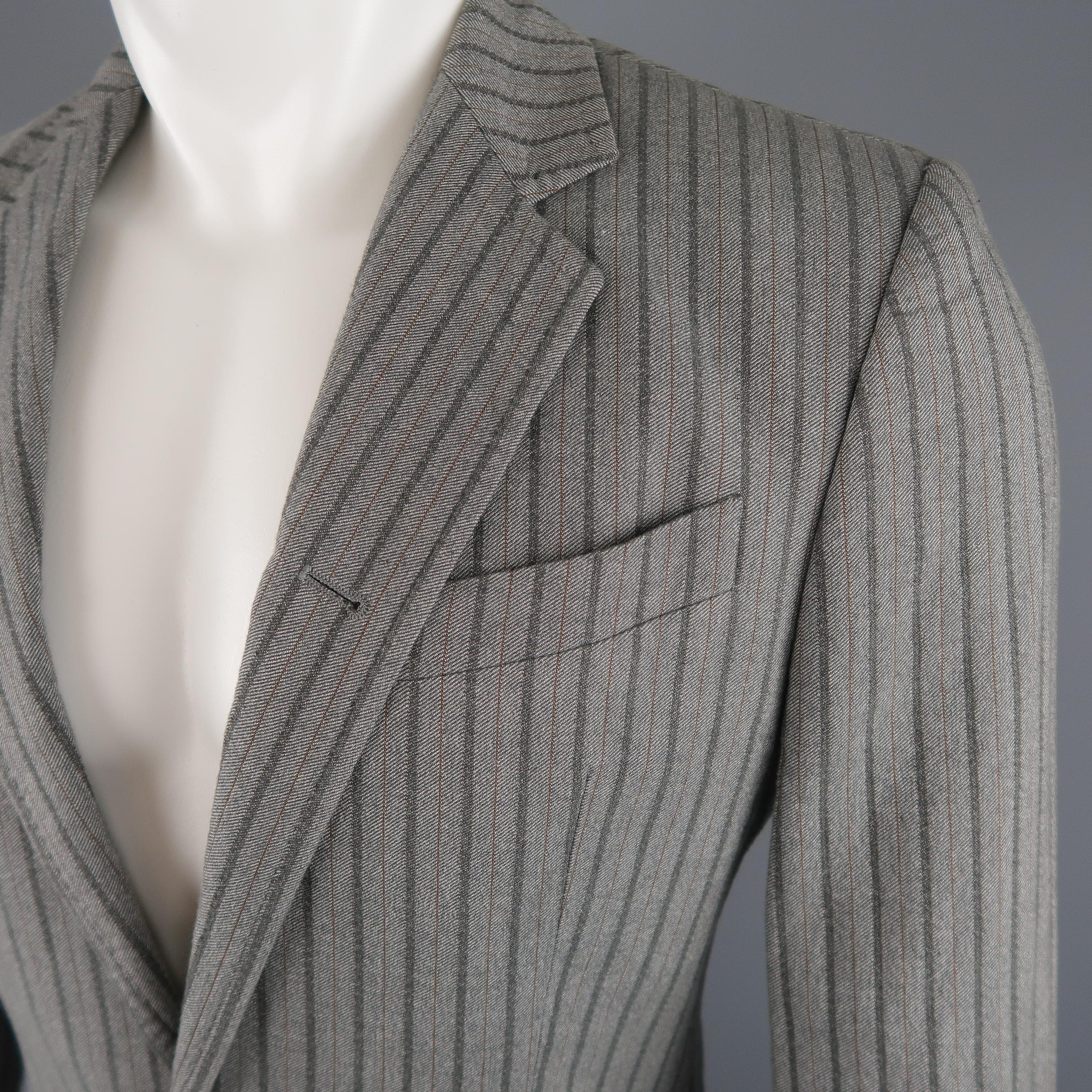 ANN DEMEULEMEESTER sport coat comes in light gray striped cotton blend fabric with a notch lapel, two button , single breasted front, and functional button cuffs.
 
Excellent Pre-Owned Condition.
Marked: S
 
Measurements:
 
Shoulder: 17 in.
Chest: