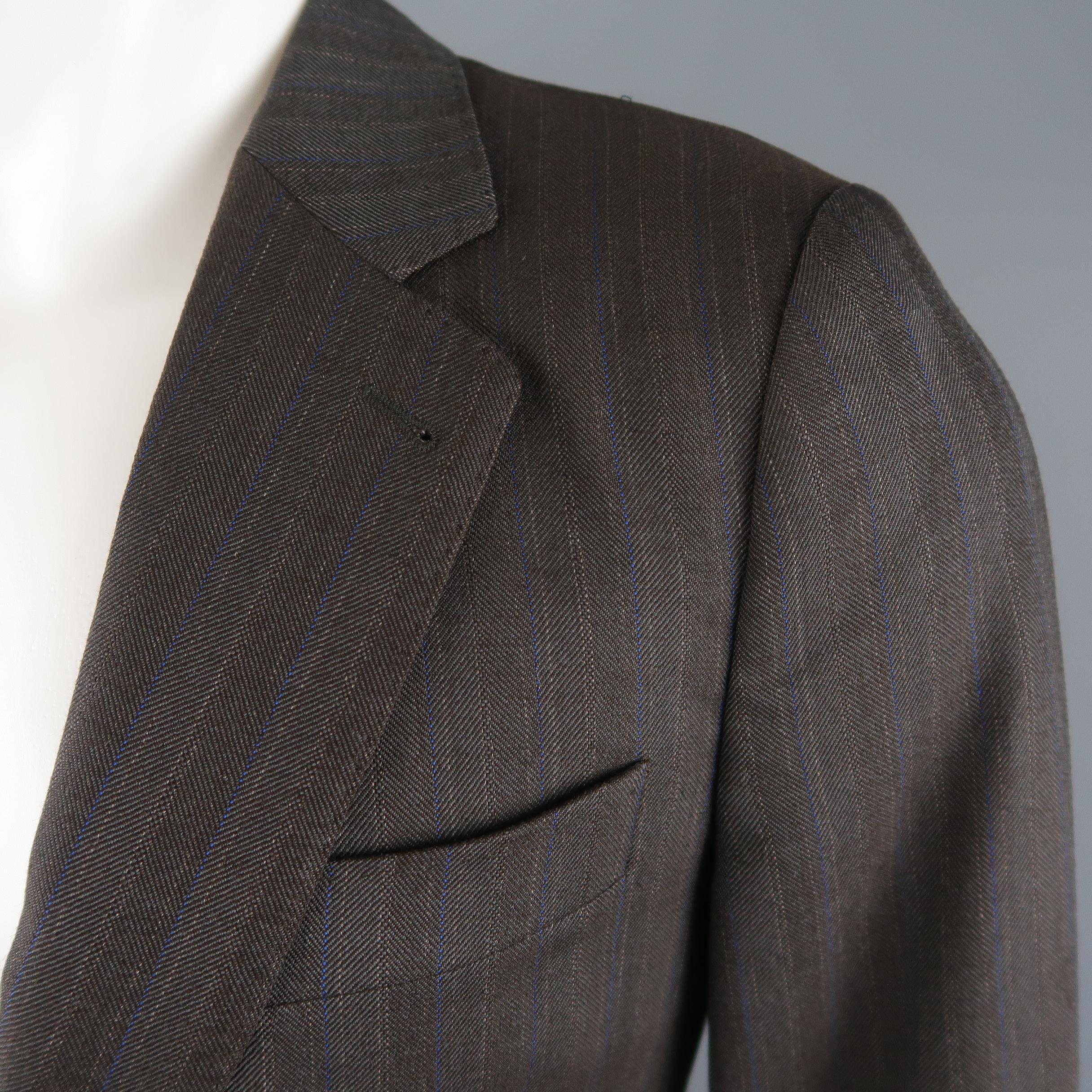 DRIES VAN NOTEN sport coat comes in brown and blue striped wool blend twill with a single breasted, two button closure, top stitching, and functional button cuffs. Made in Morocco.
 
Excellent Pre-Owned Condition.
Marked: IT 46
 
Measurements:
